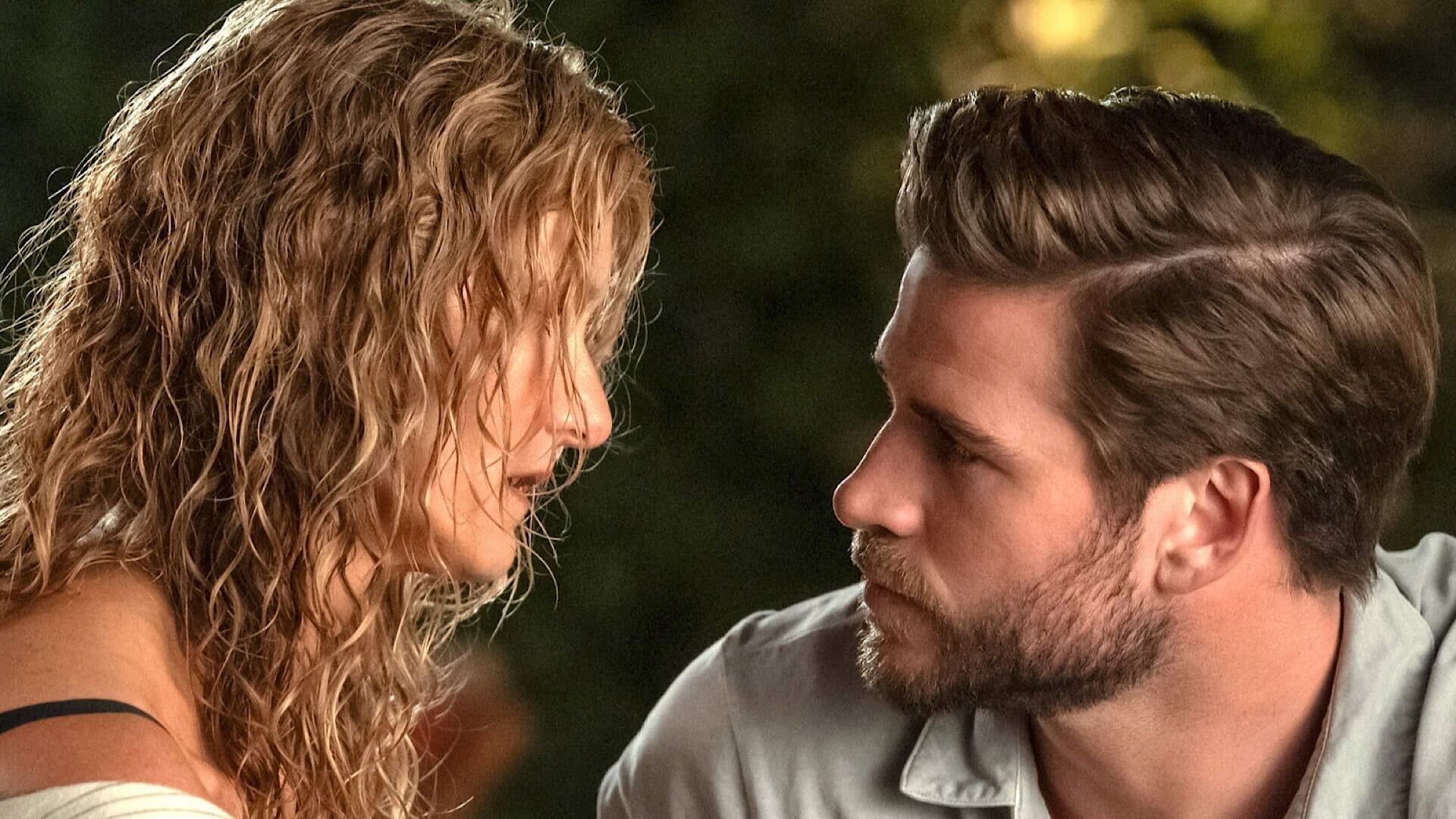 Laura Dern and Liam Hemsworth look at each other in Netflix movie Lonely Planet