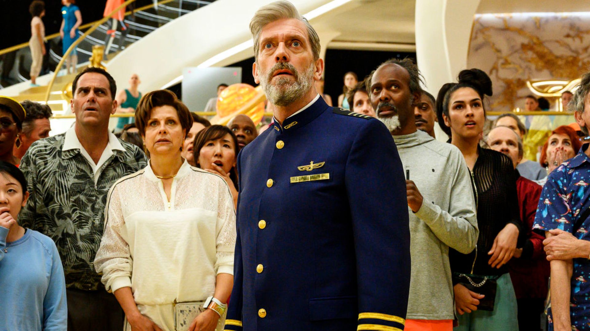 Hugh Laurie in front of a crowd of scared people in Avenue 5