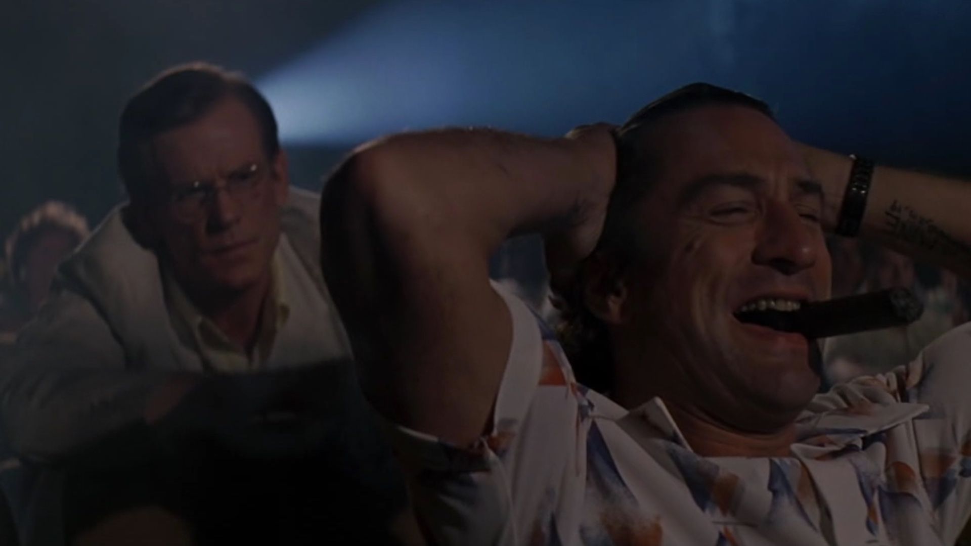 Robert De Niro laughs in a theater in the film cape fear