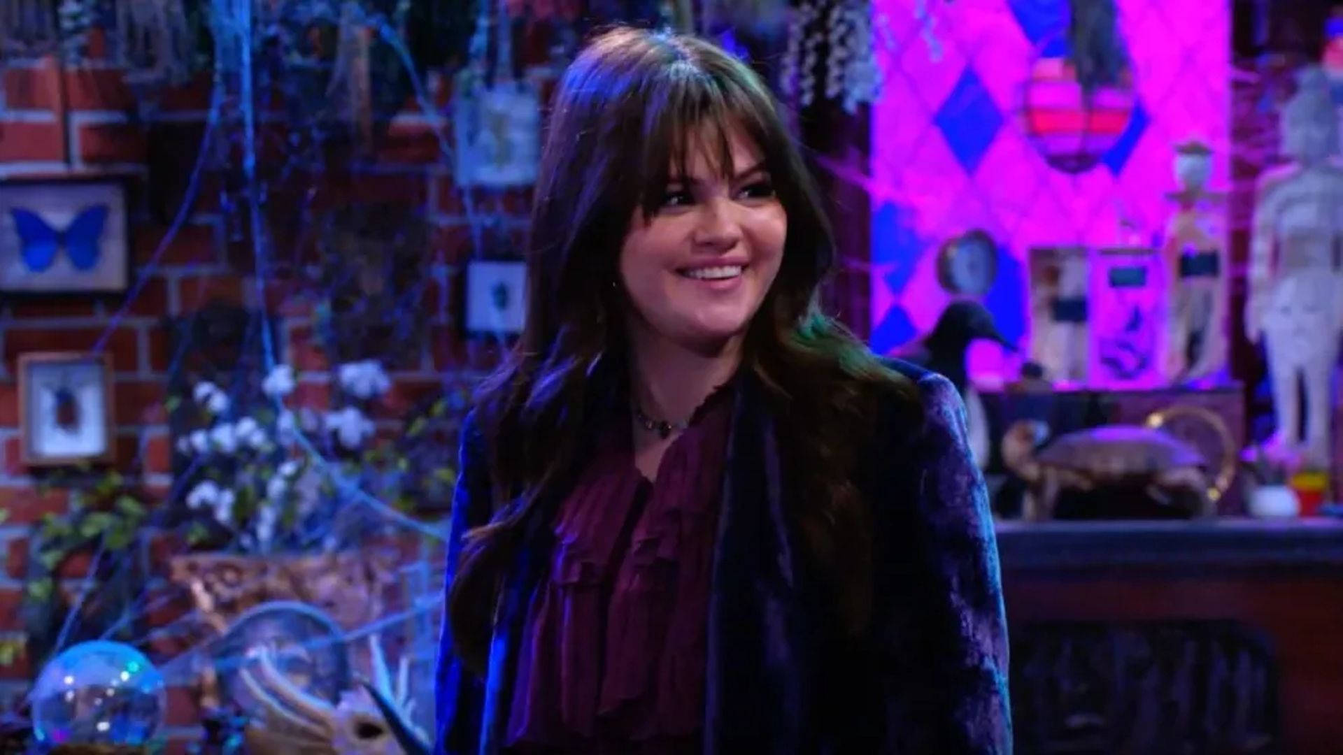 Alex smiles in the basement in Wizards Beyond Waverly Place