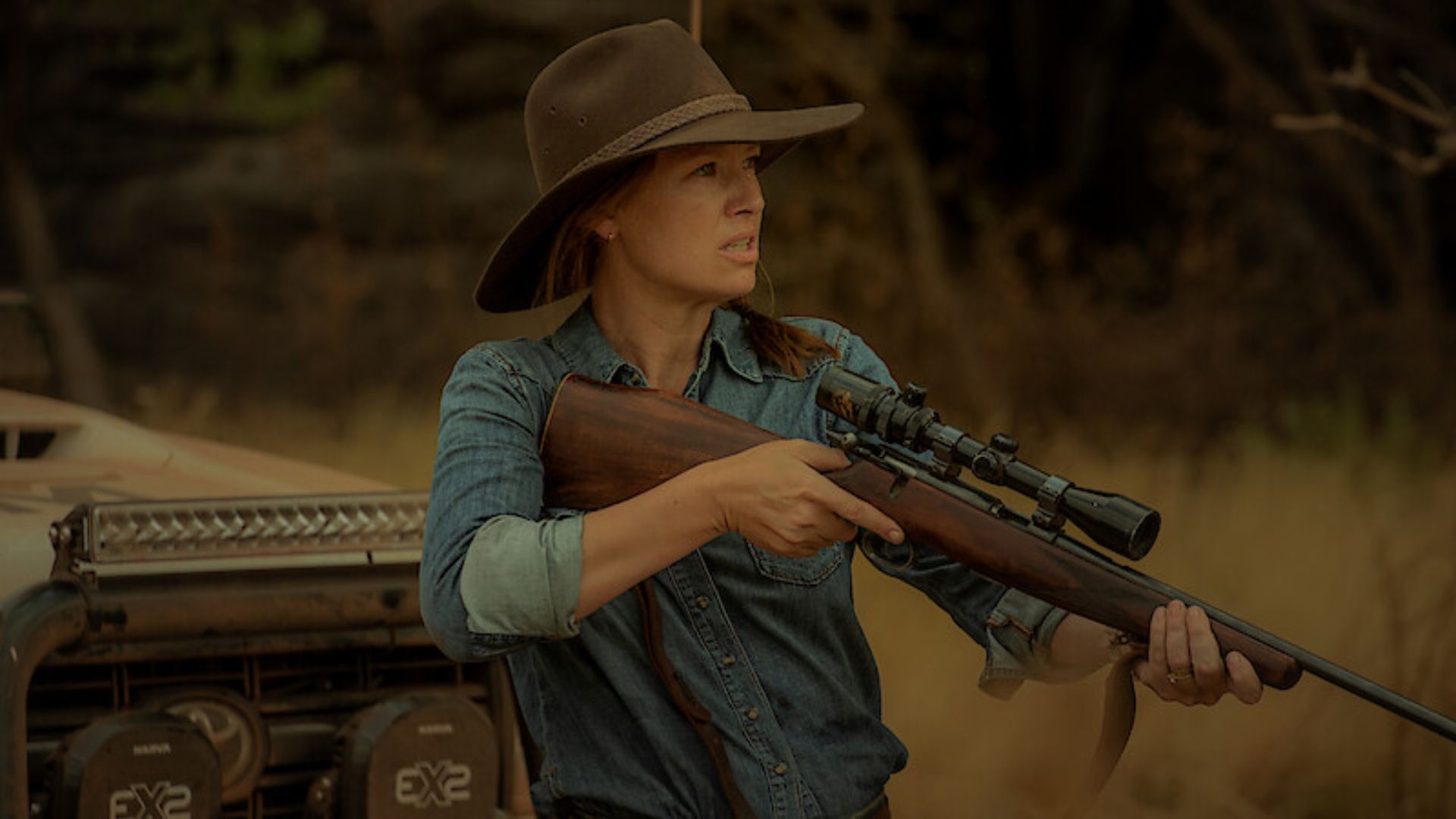 Emily holding a gun in Territory