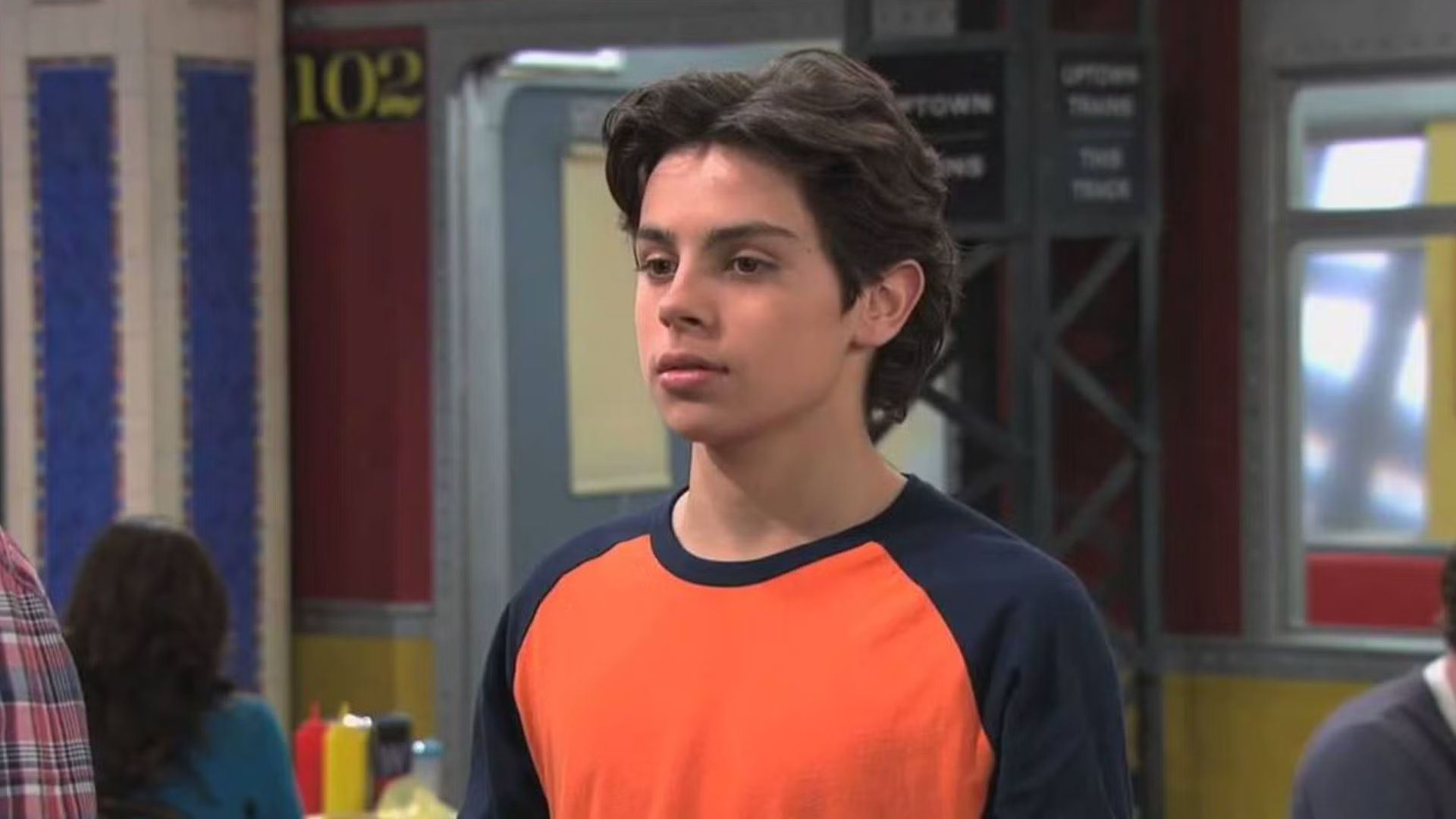 Max stands in the cafeteria in Wizards of Waverly Place