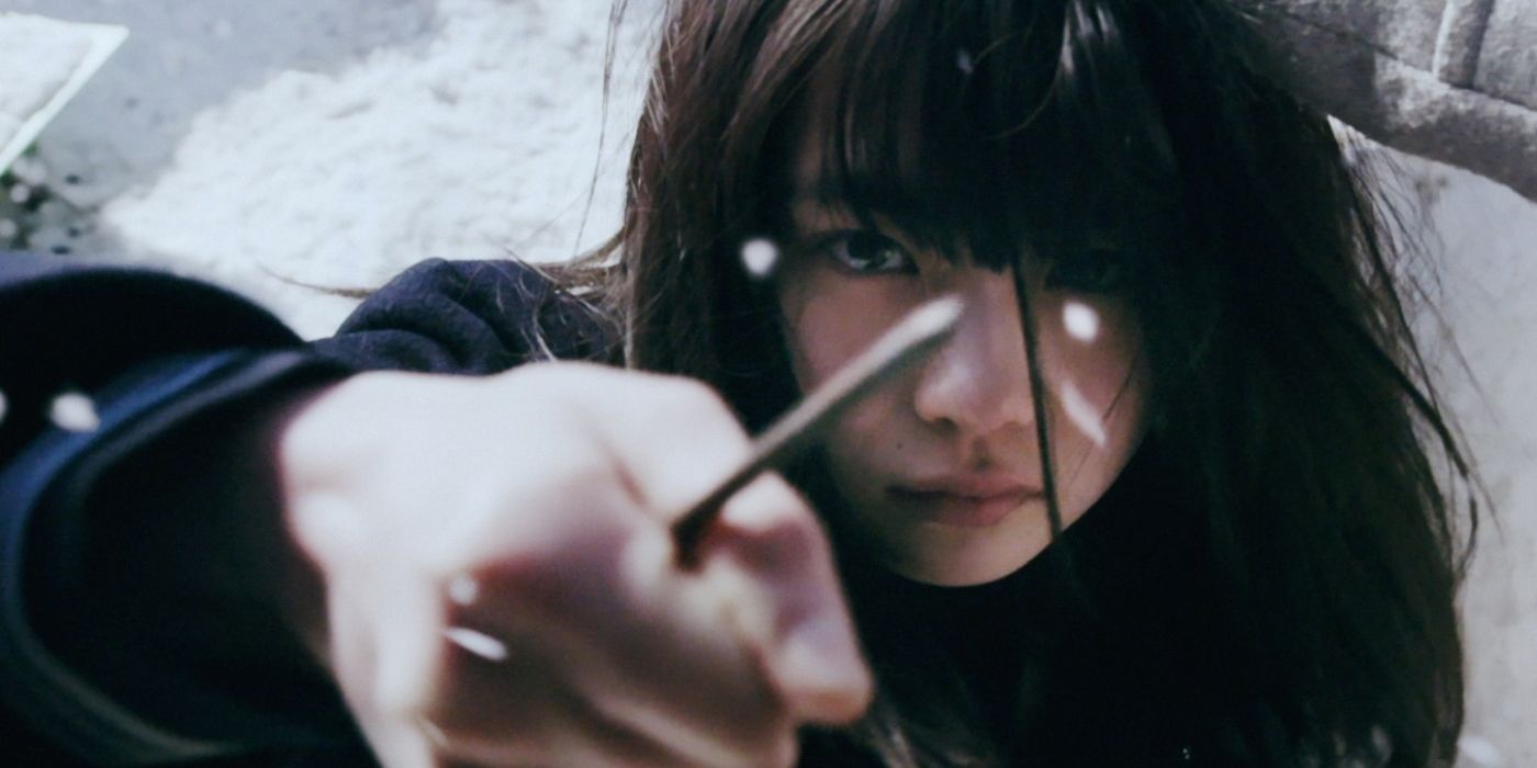 A girl holds a knife to the camera in Liverleaf