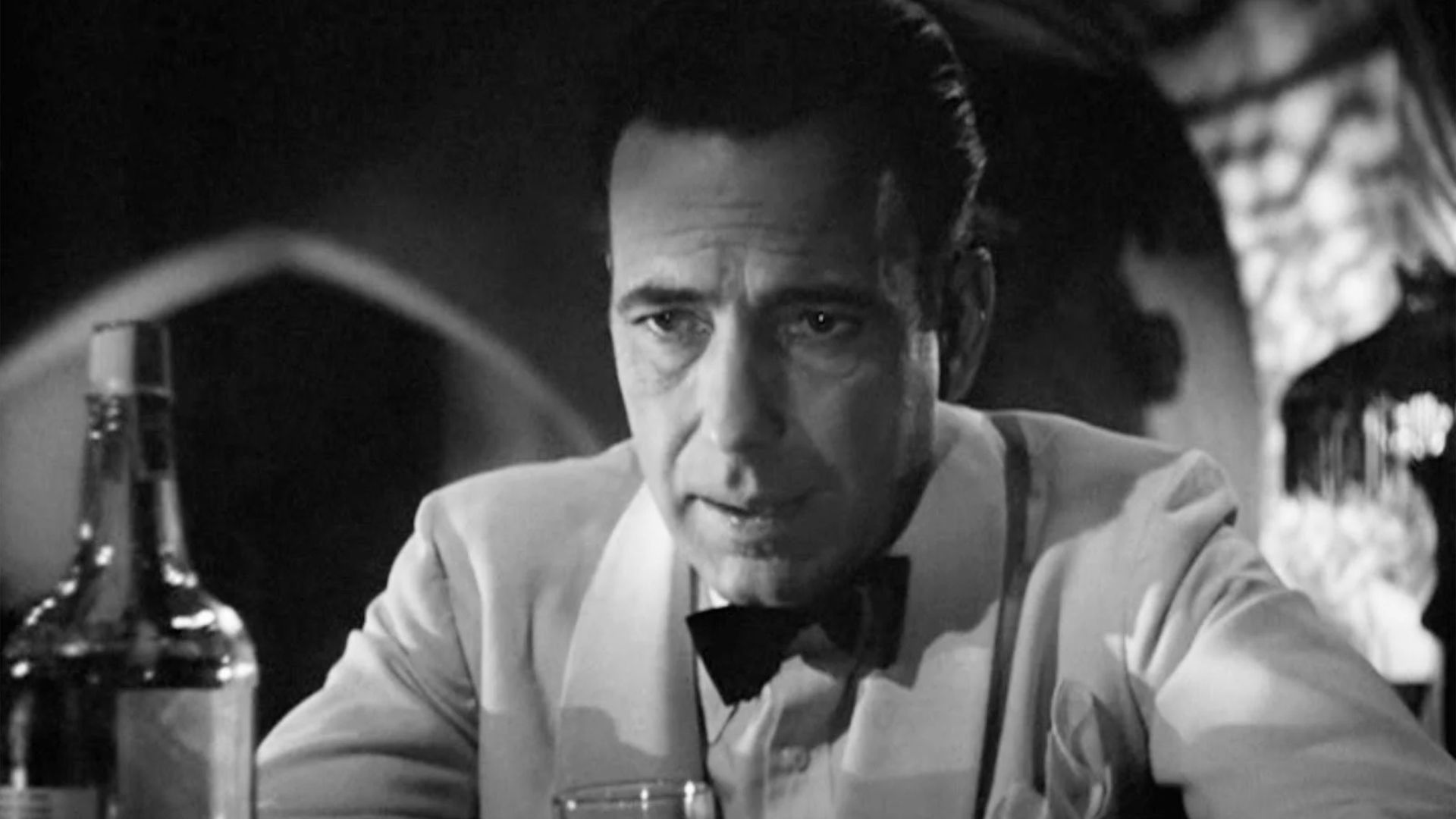 Humphrey Bogart as Rick drinking in Casablanca