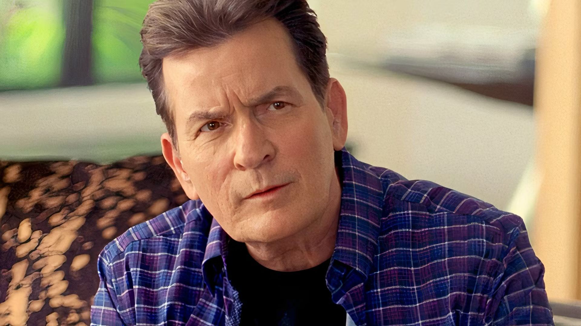 Charlie Sheen wears a blue shirt in Ramble On