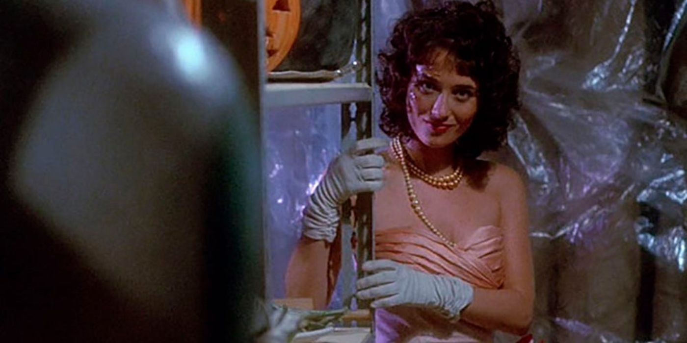 a young woman in a prom dress smiles in hello mary lou prom night II