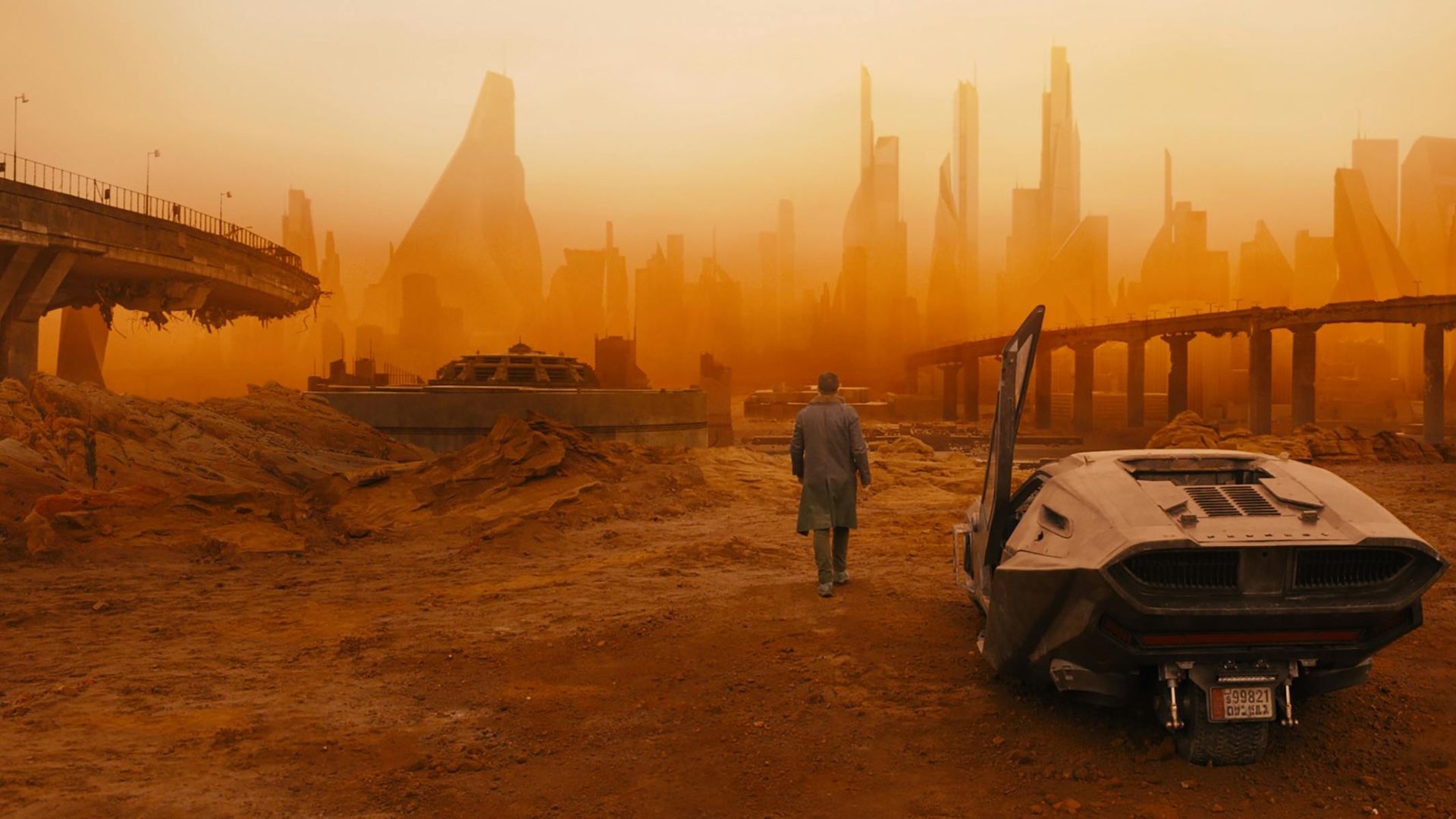Ryan Gosling as K walking out of his car in Blade Runner 2049