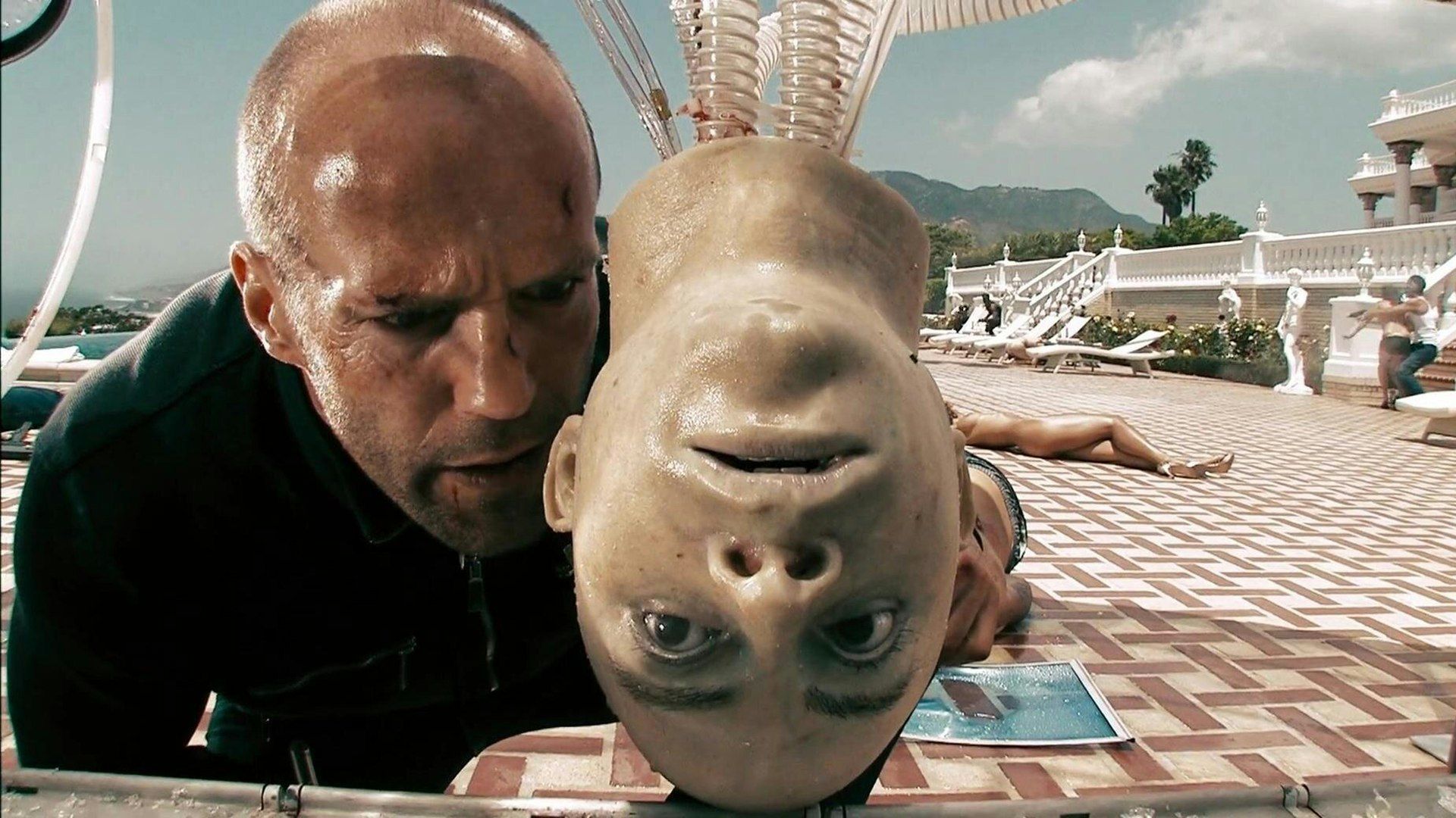 Chev stares at a fake head in Crank High Voltage