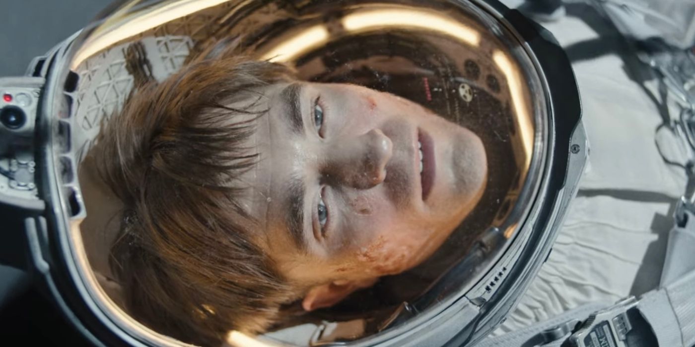 Robert Pattinson in an astronaut suit looking up in the movie Mickey 17