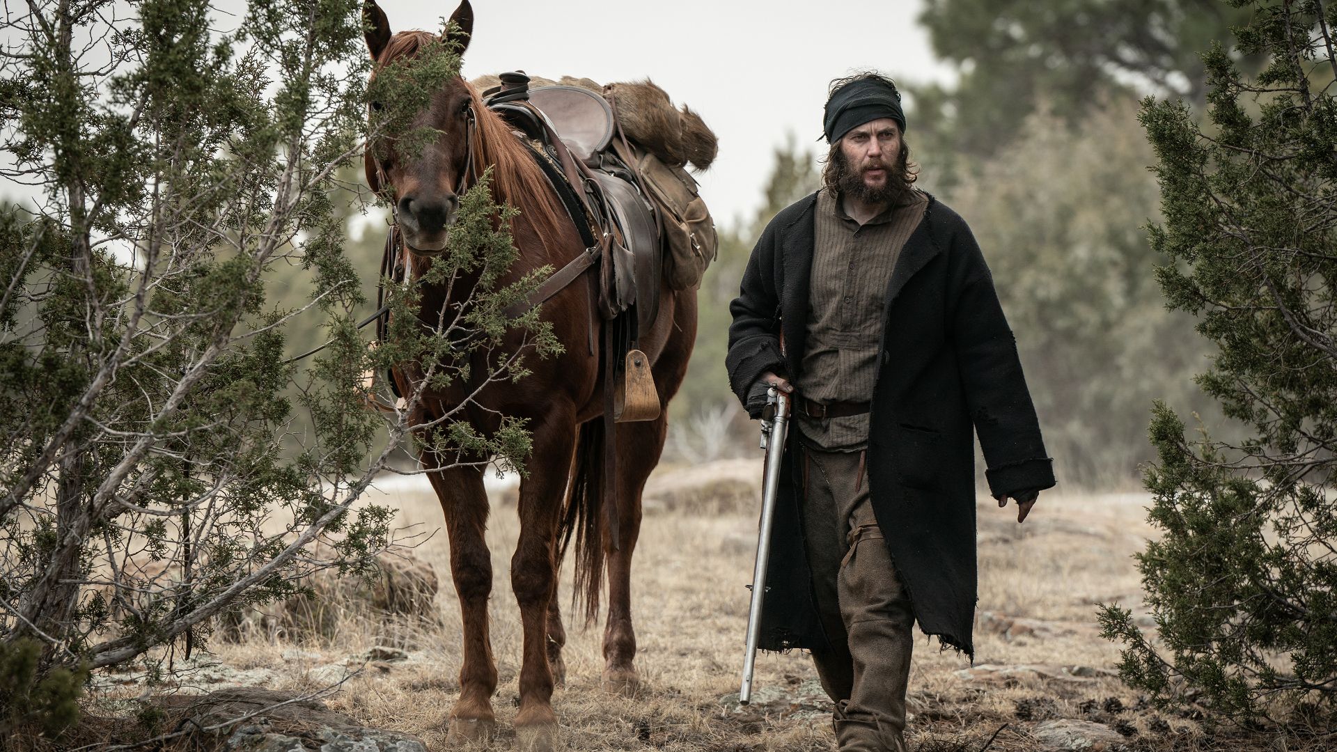 Taylor Kitsch by his horse in the Netflix Western series American Primeval