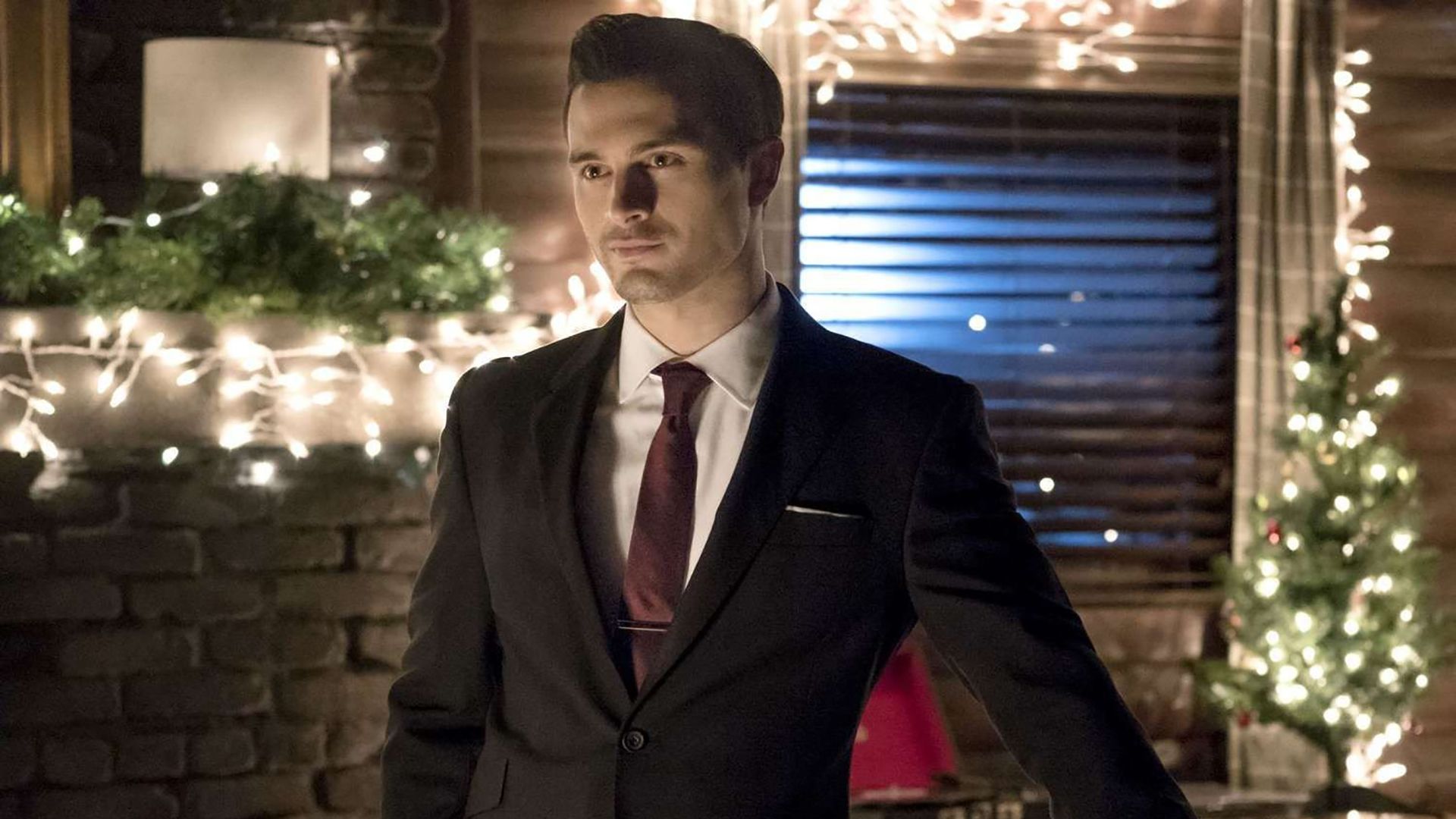 Enzo from The Vampire Diaries standing in a suit.