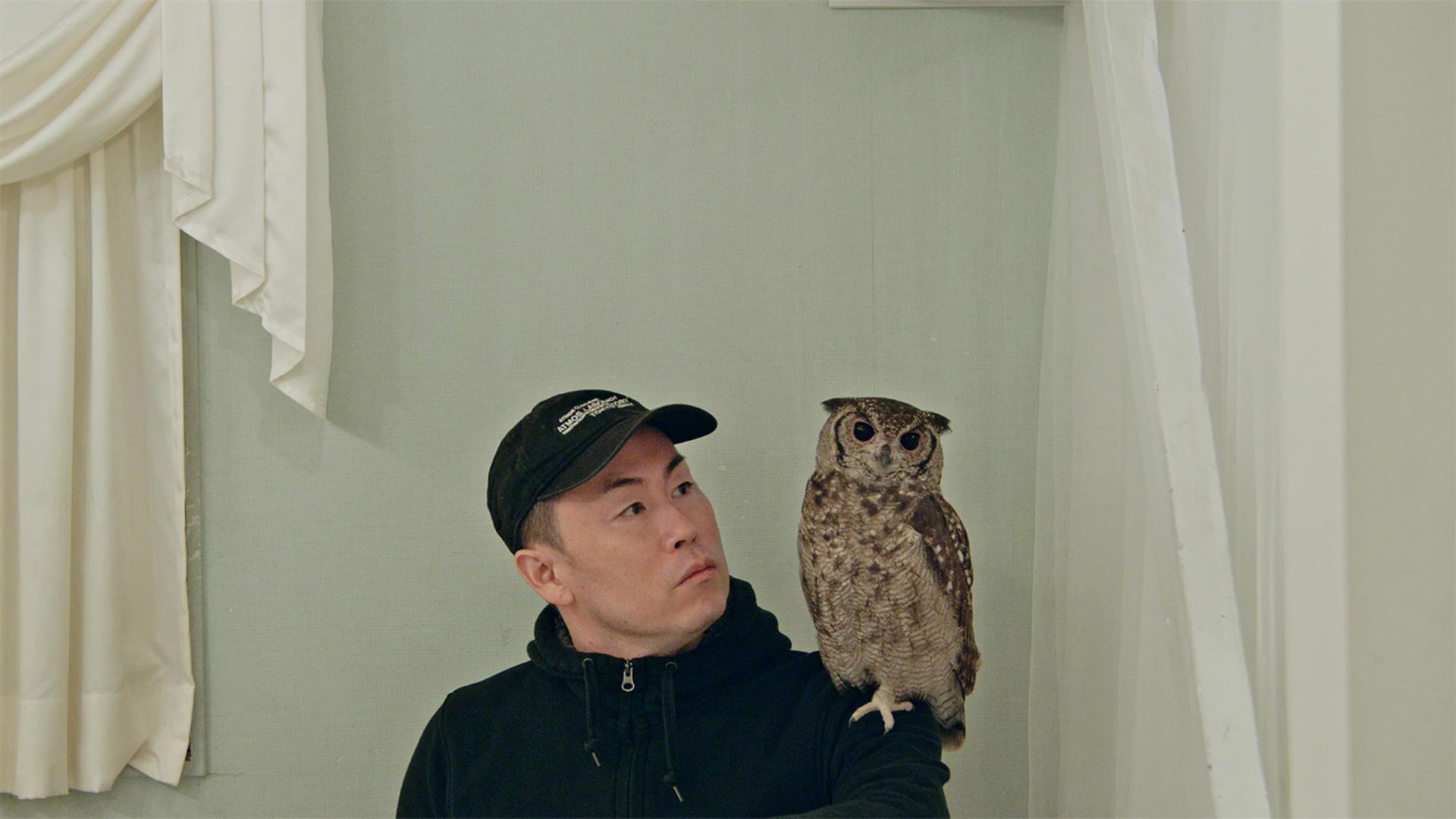 A Japanese man with an owl on his shoulder in the movie Dear Tomorrow