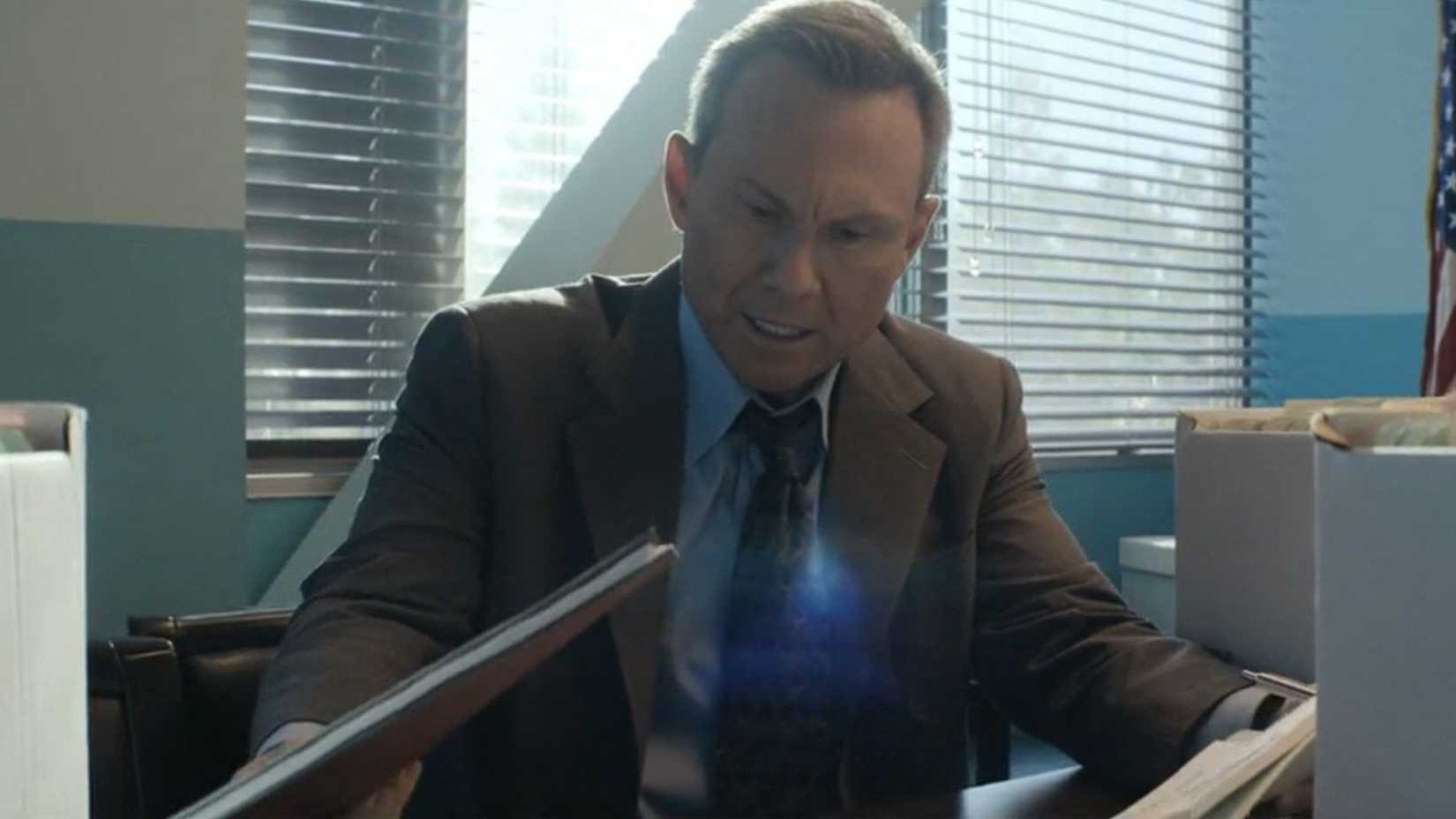 Harry looking at files, clearly disturbed in Dexter: Original Sin