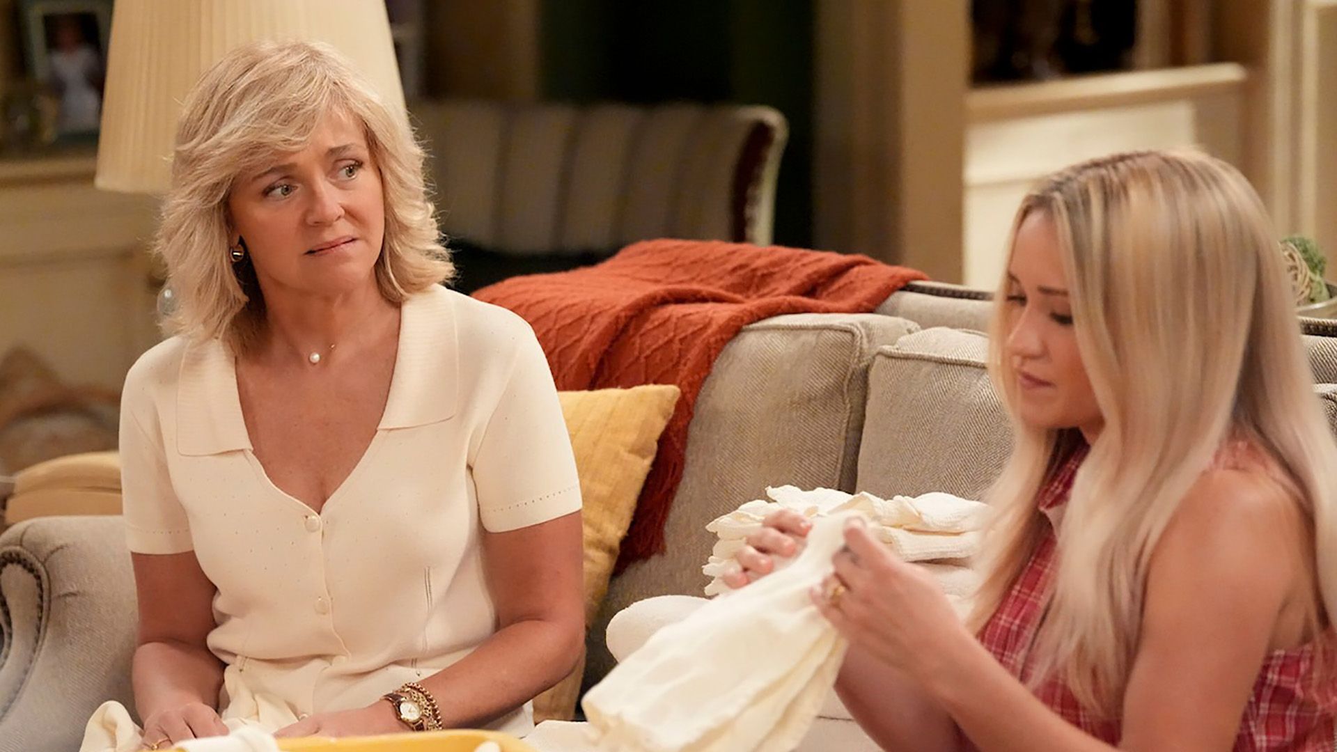 Audrey looks upset as she folds laundry with Mandy in Georgie and Mandy's First Marriage.