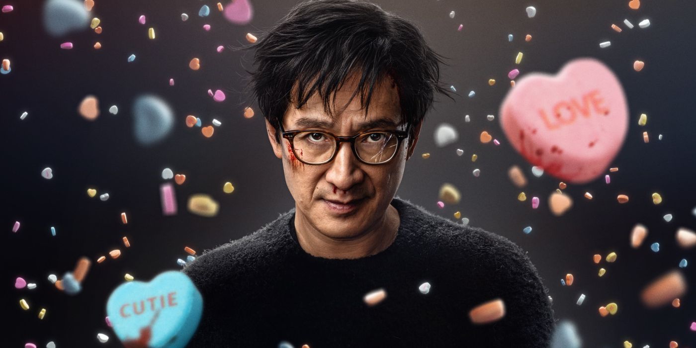 Ke Huy Quan with broken glasses surrounded by candy hearts in the 2025 movie Love Hurts