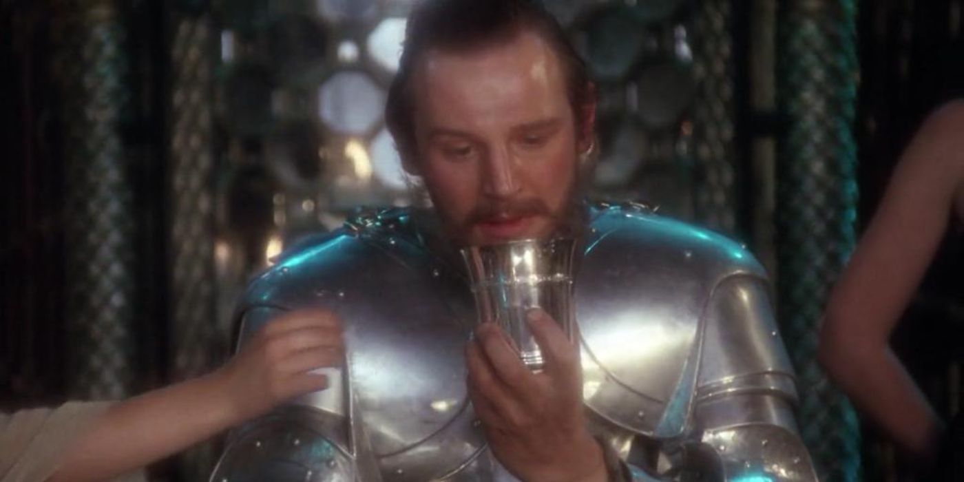 Liam Neeson as Gawain holding a chalice in the 1981 movie Excalibur