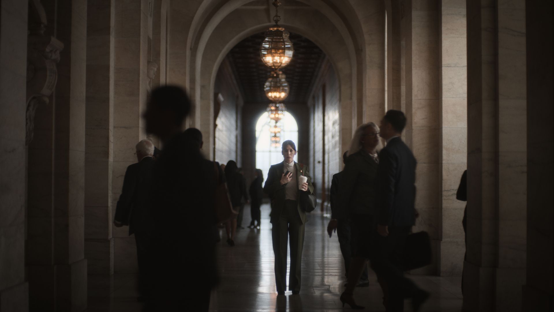 Lizzy Caplan walking through Congress in the Netflix TV series Zero Day