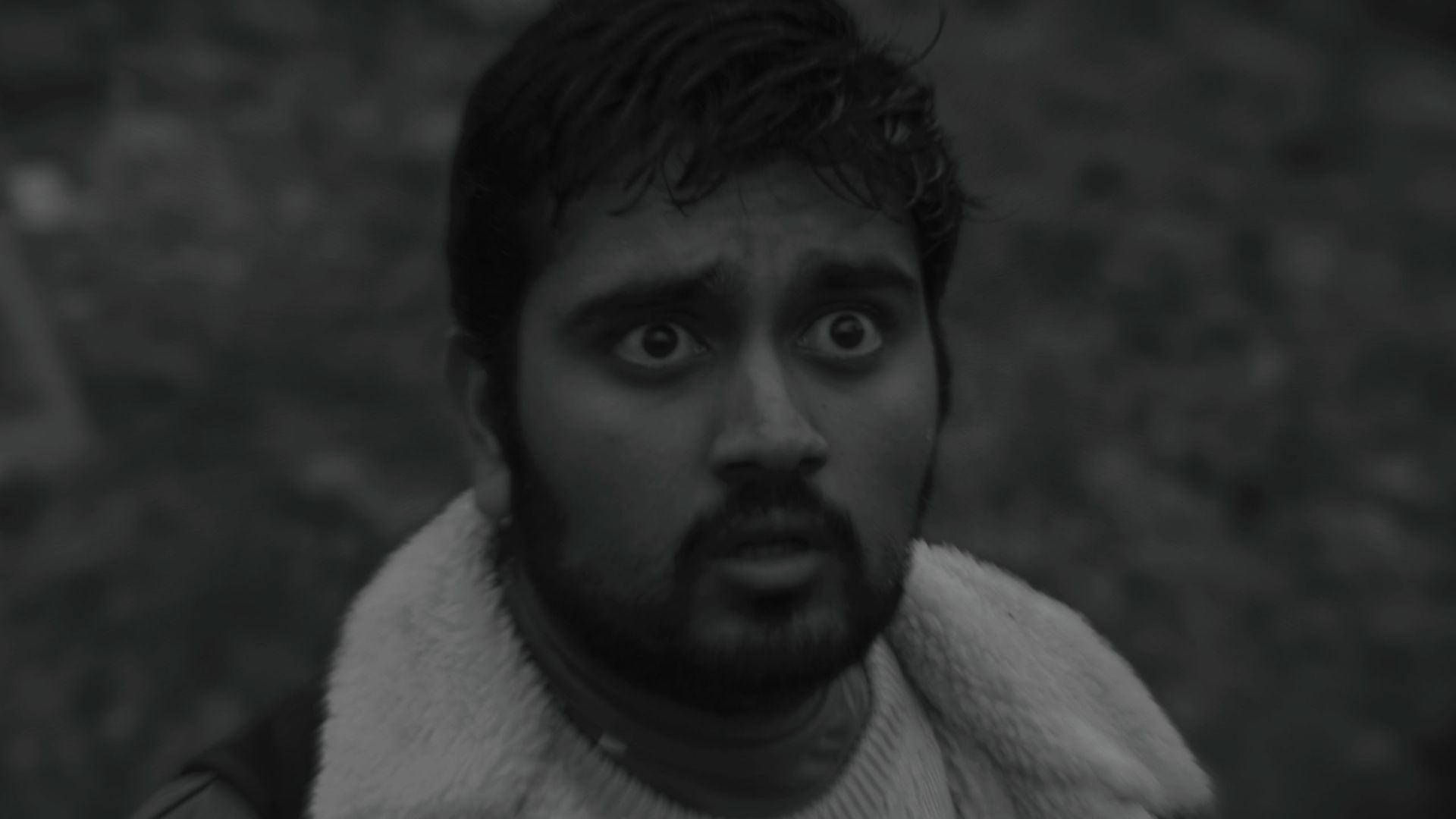 Rishi (Vishal Vijayakumar) looks terrified in black and white movie Didn't Die from Sundance 2025