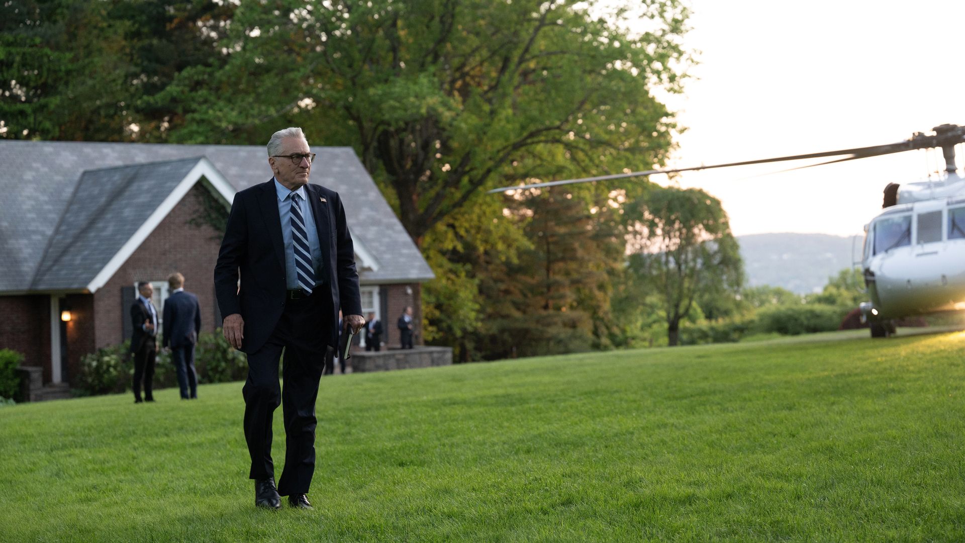 Robert De Niro as President George Mullen walks on grass to a helicopter in Zero Day on Netflix