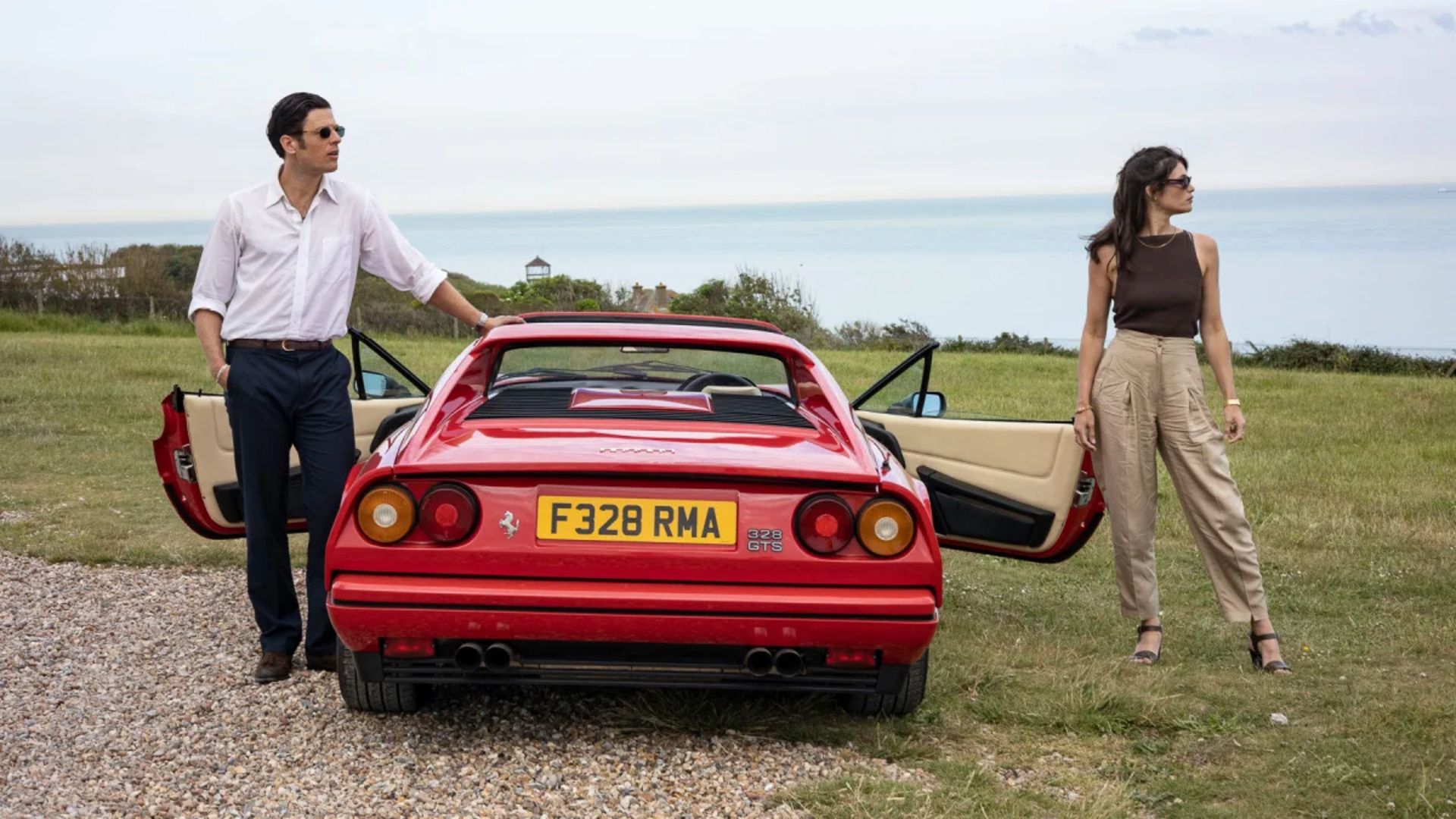 Robert and Alice exit a Ferrari in Rogue Agent