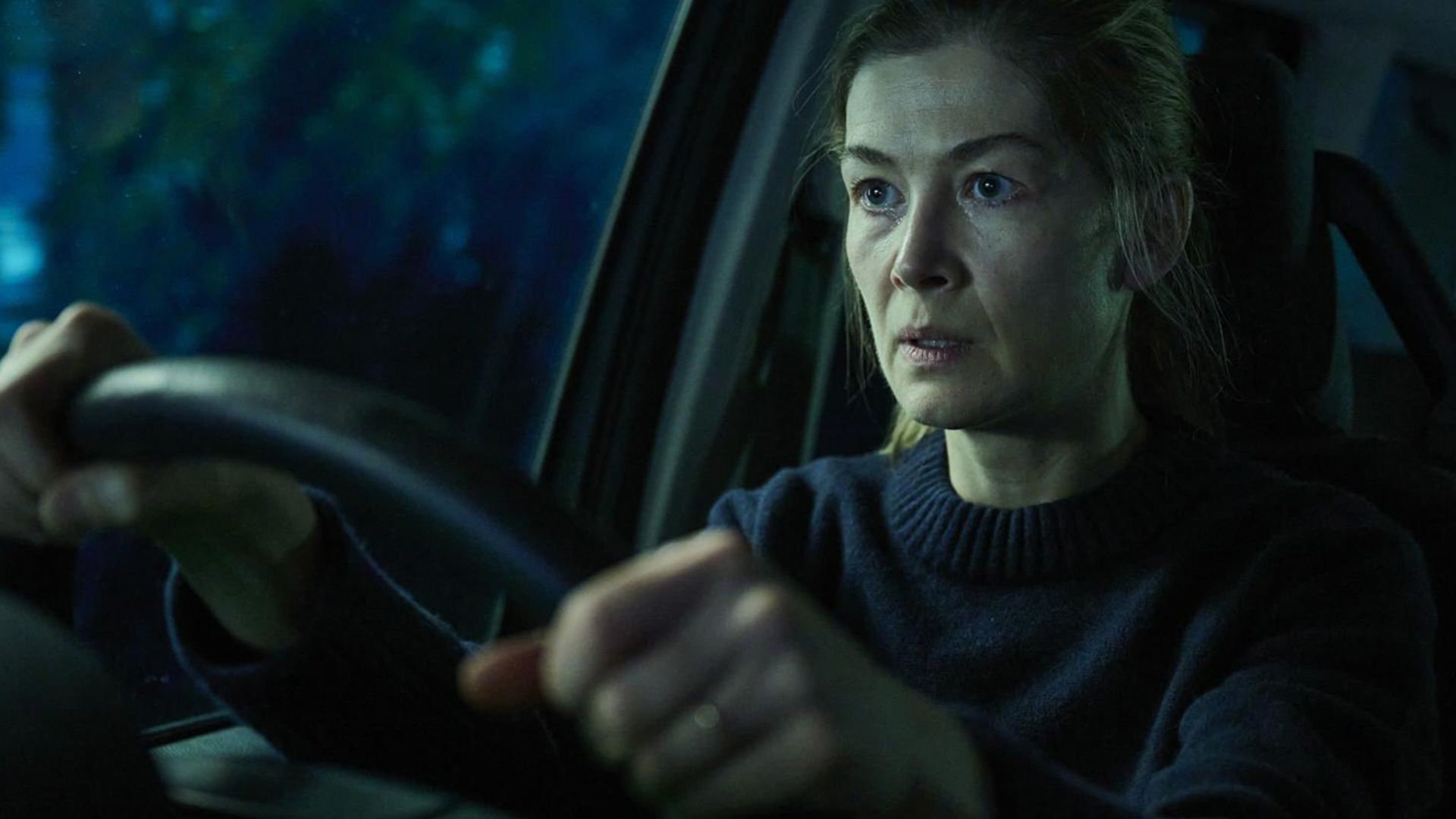 Rosamund Pike behind the wheel in the movie Hallow Road