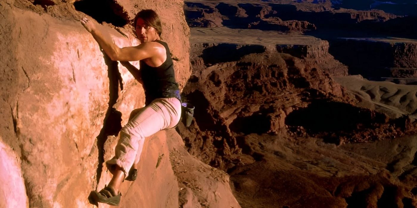 tom cruise climbs a rock in mission impossible 2