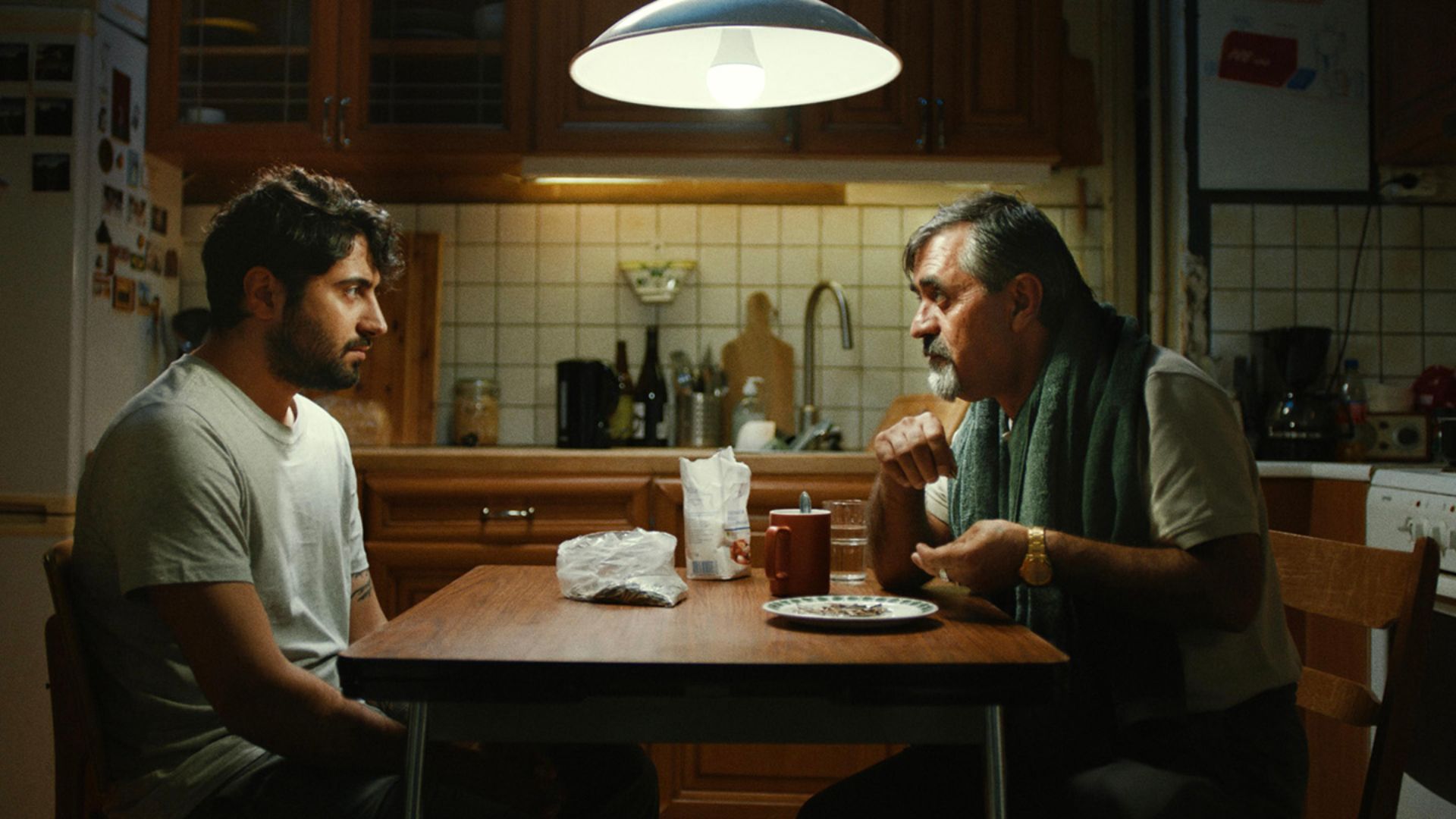 Two men at a kitchen table in the movie My Uncle Jens