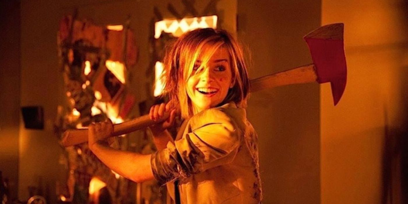 Emma Watson holding an ax and smiling in This is the End
