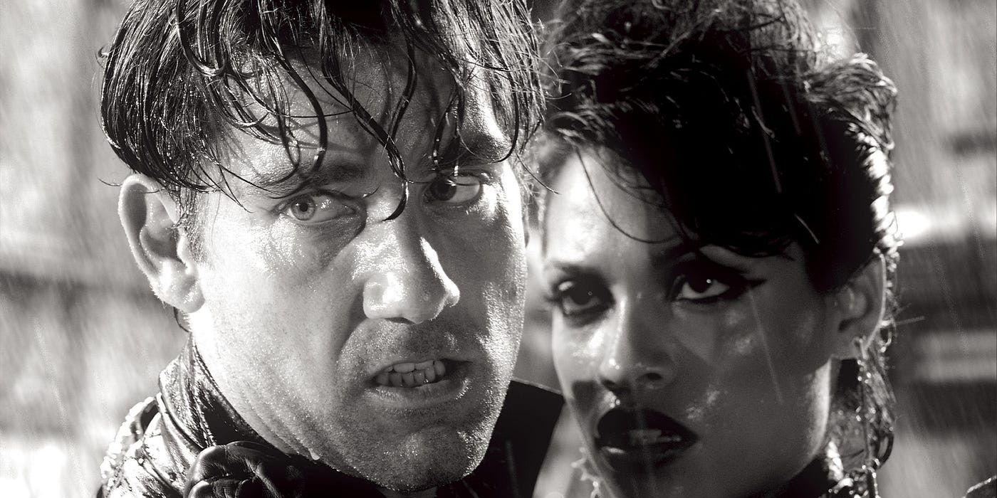 Clive Owen and Rosario Dawson stand in the rain in Sin City