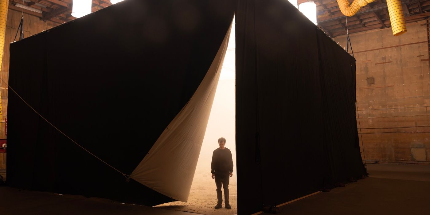 Nathan Fielder exiting a square tent in a warehouse in The Rehearsal Season 2 Episode 1