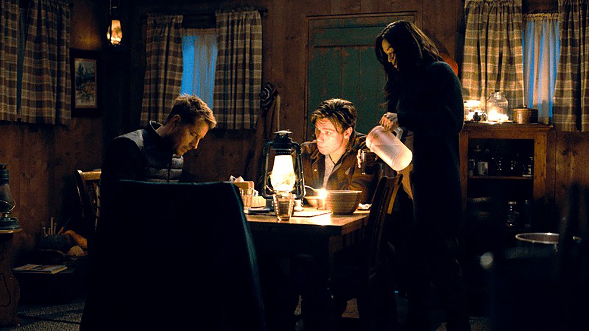 Colter sitting at the table with Dash and Amelia looks on in Tracker
