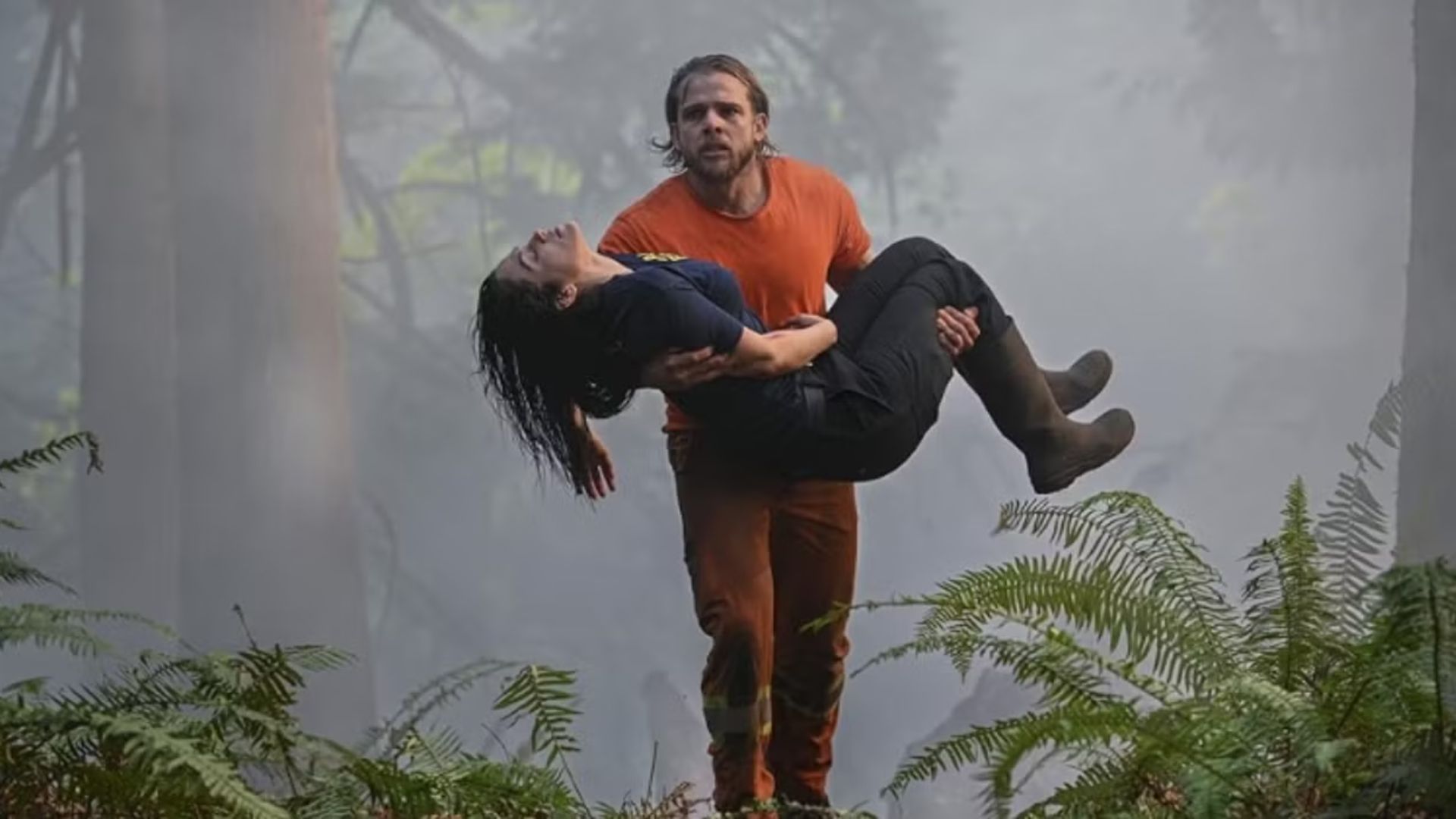 Bode carries Gabi out of the forest in Fire Country