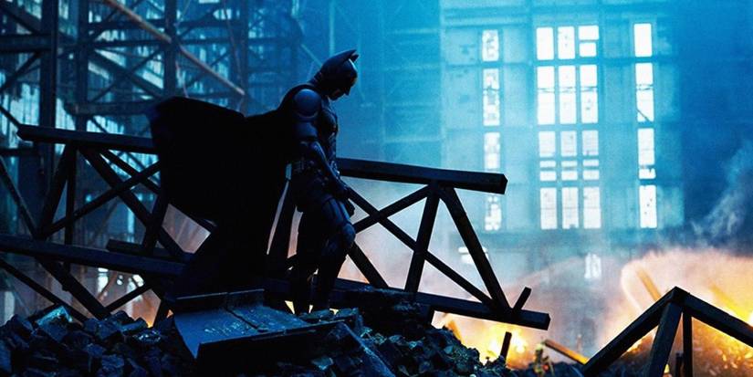 batman stands amid ruins in the dark knight