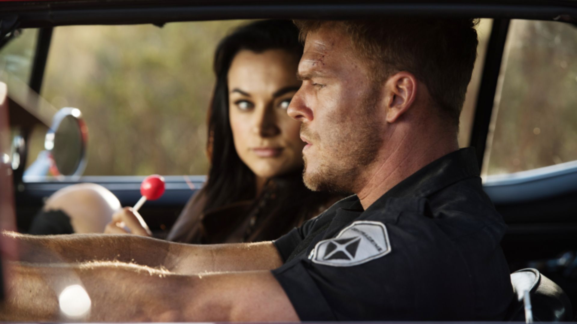 Grace holds a lollipop in the car in Blood Drive