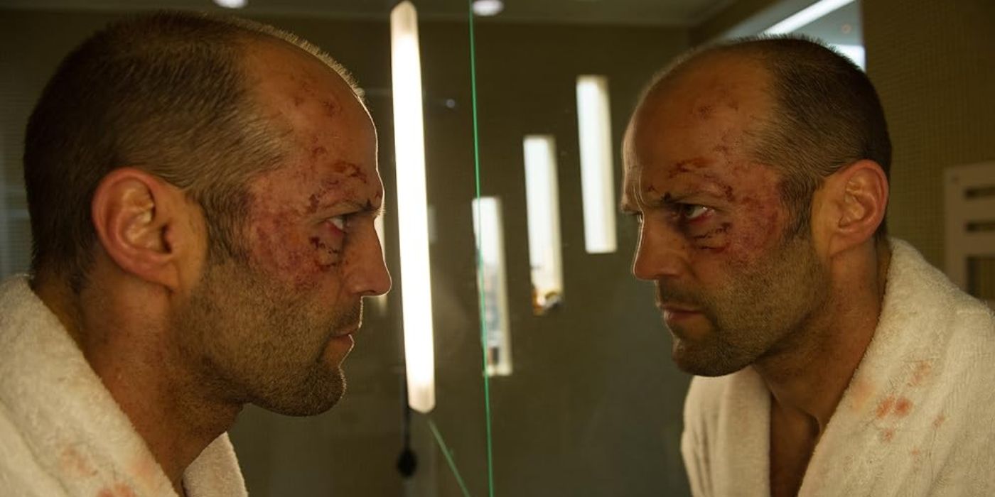 Jason Statham stares at himself in a mirror in Redemption