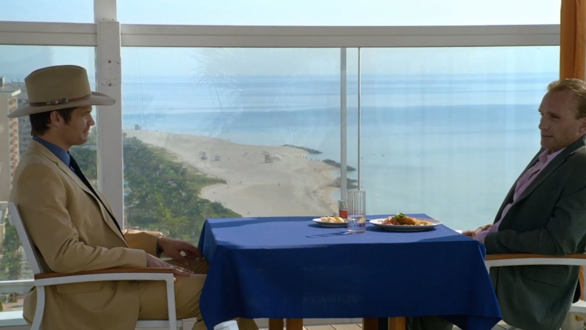 Raylan and Tom face off at a seaside table in Justified