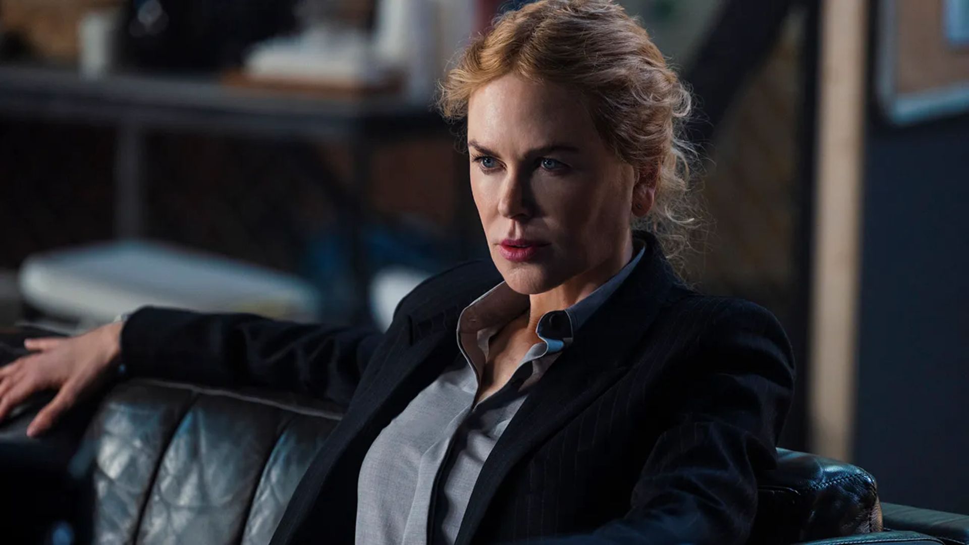 Kaitlyn sits on a sofa in Special Ops: Lioness