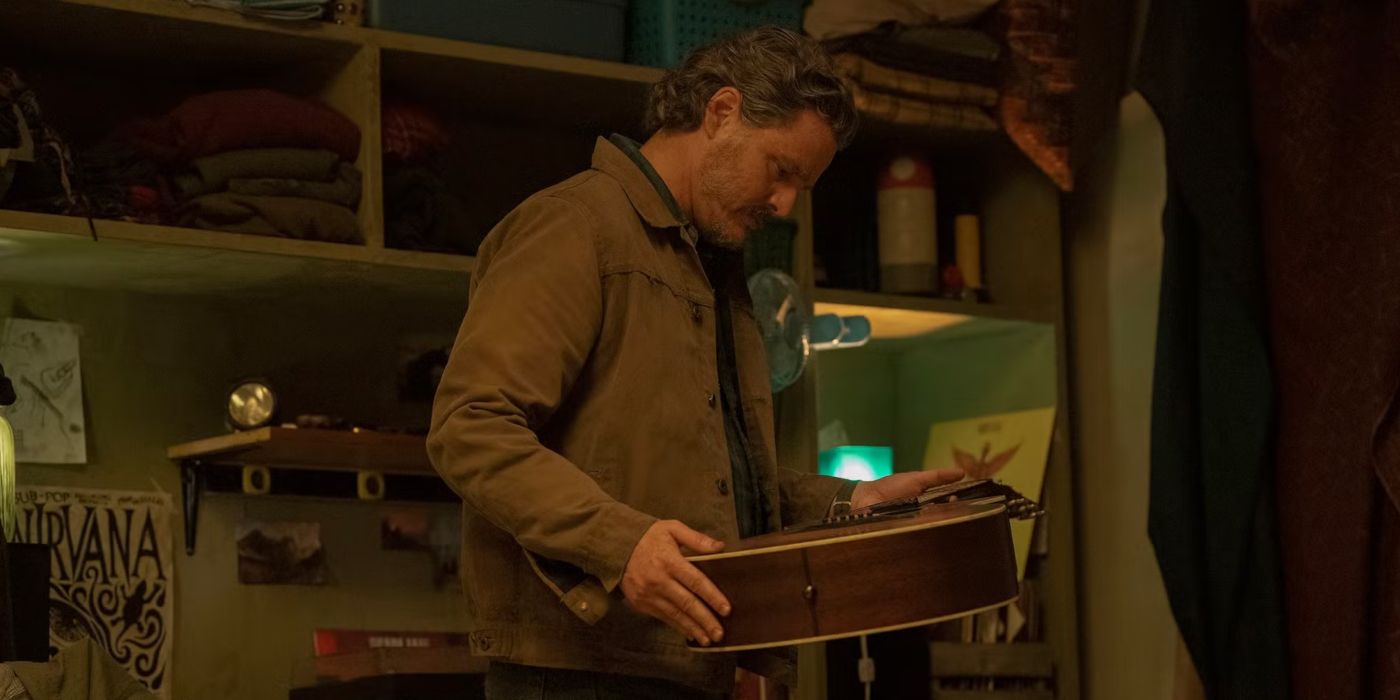 Pedro Pascal as Joel looking at a guitar in The Last of Us