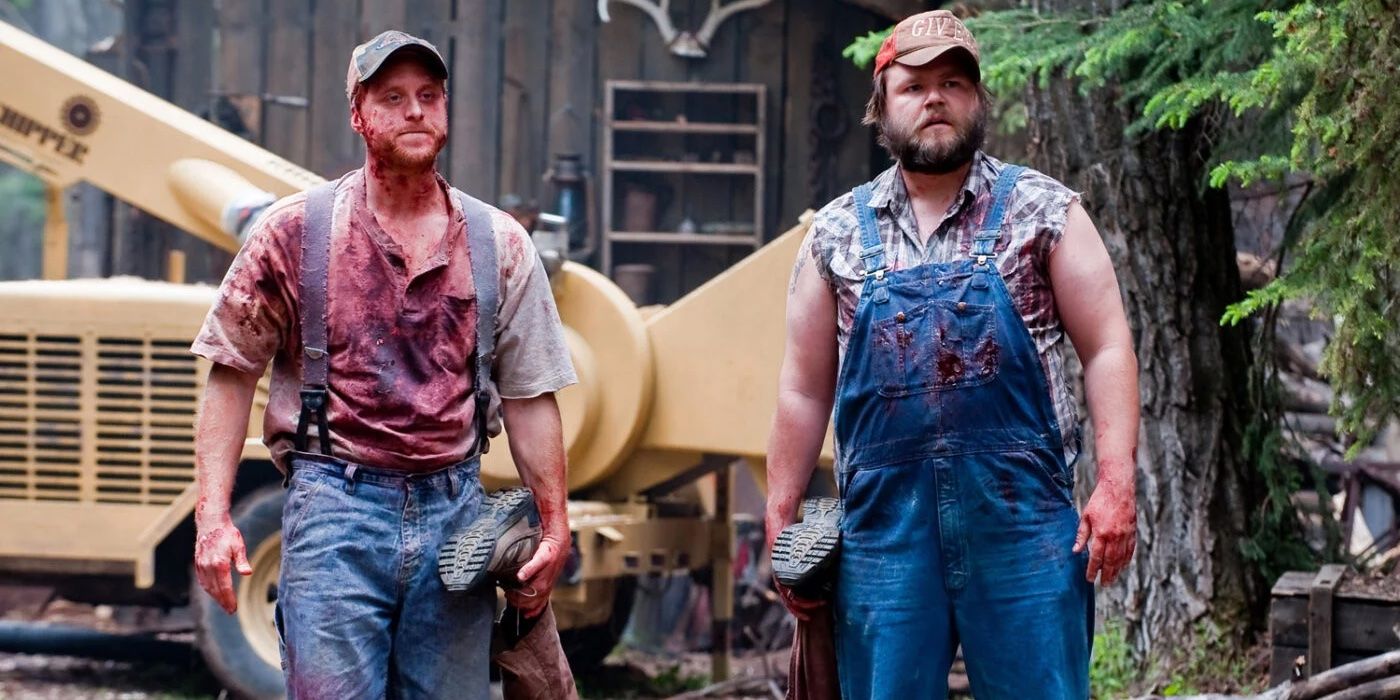 Alan Tudyk's Tucker McGee and Tyler Labine's Dale Dobson holding the legs of a body in Tucker & Dale vs. Evil