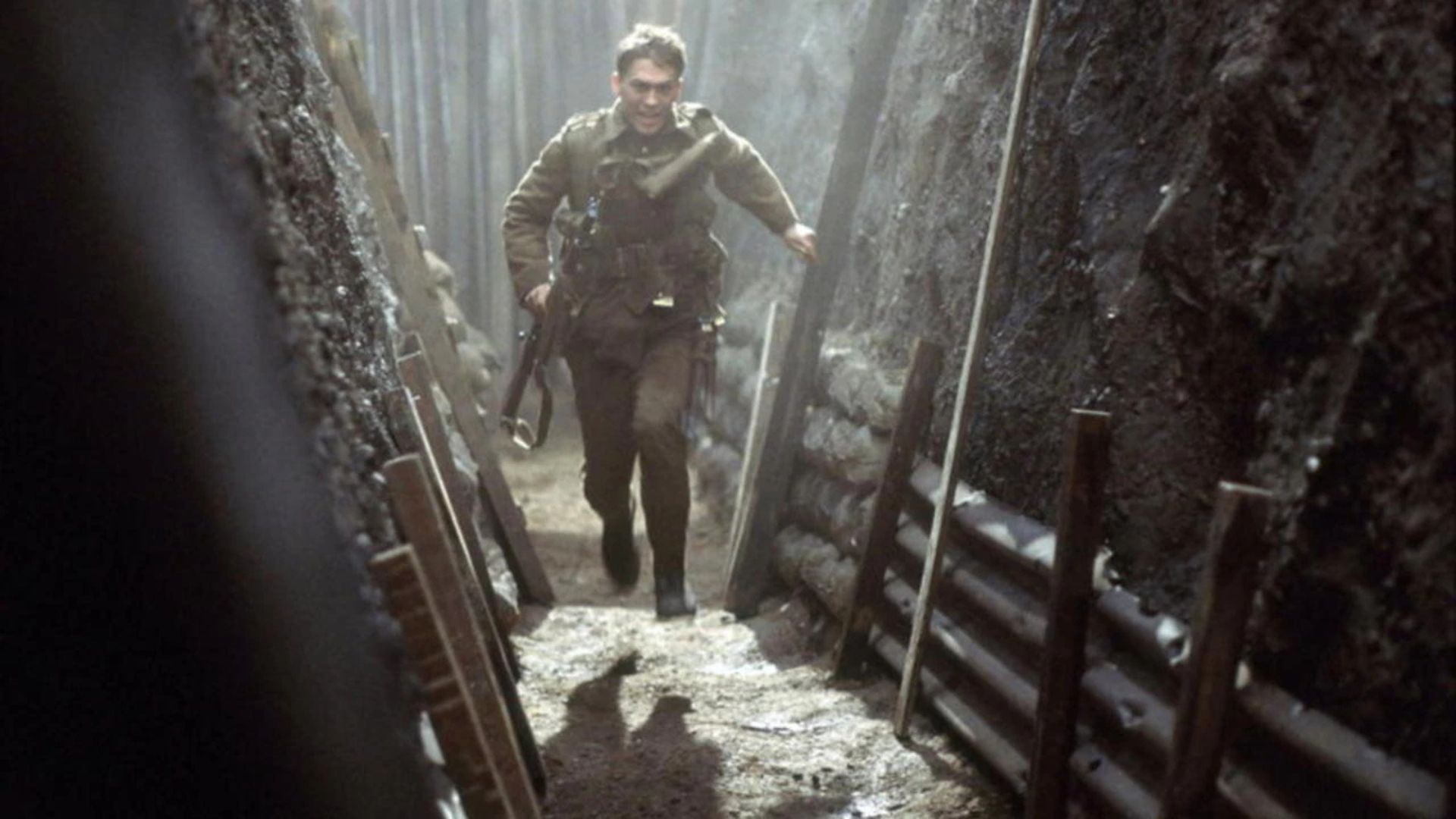 A man runs through a trench in the 1999 world war film 'The Trench'