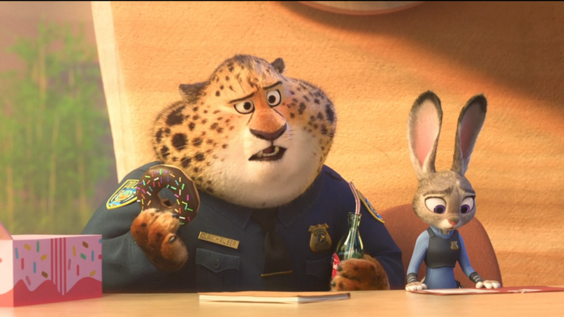 A confused Clawhauser eats a donut beside Judy in Zootopia.
