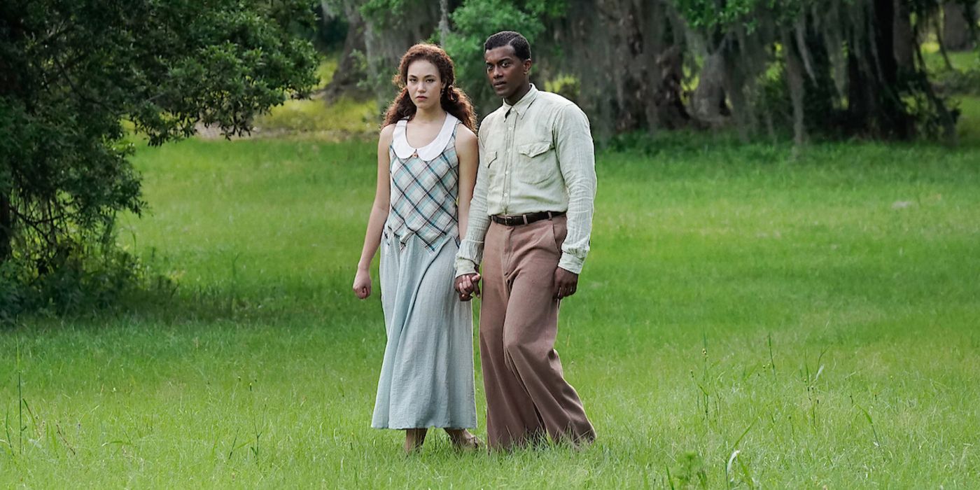 Leanne and Bayou hold hands in a field in A Jazzman's Blues