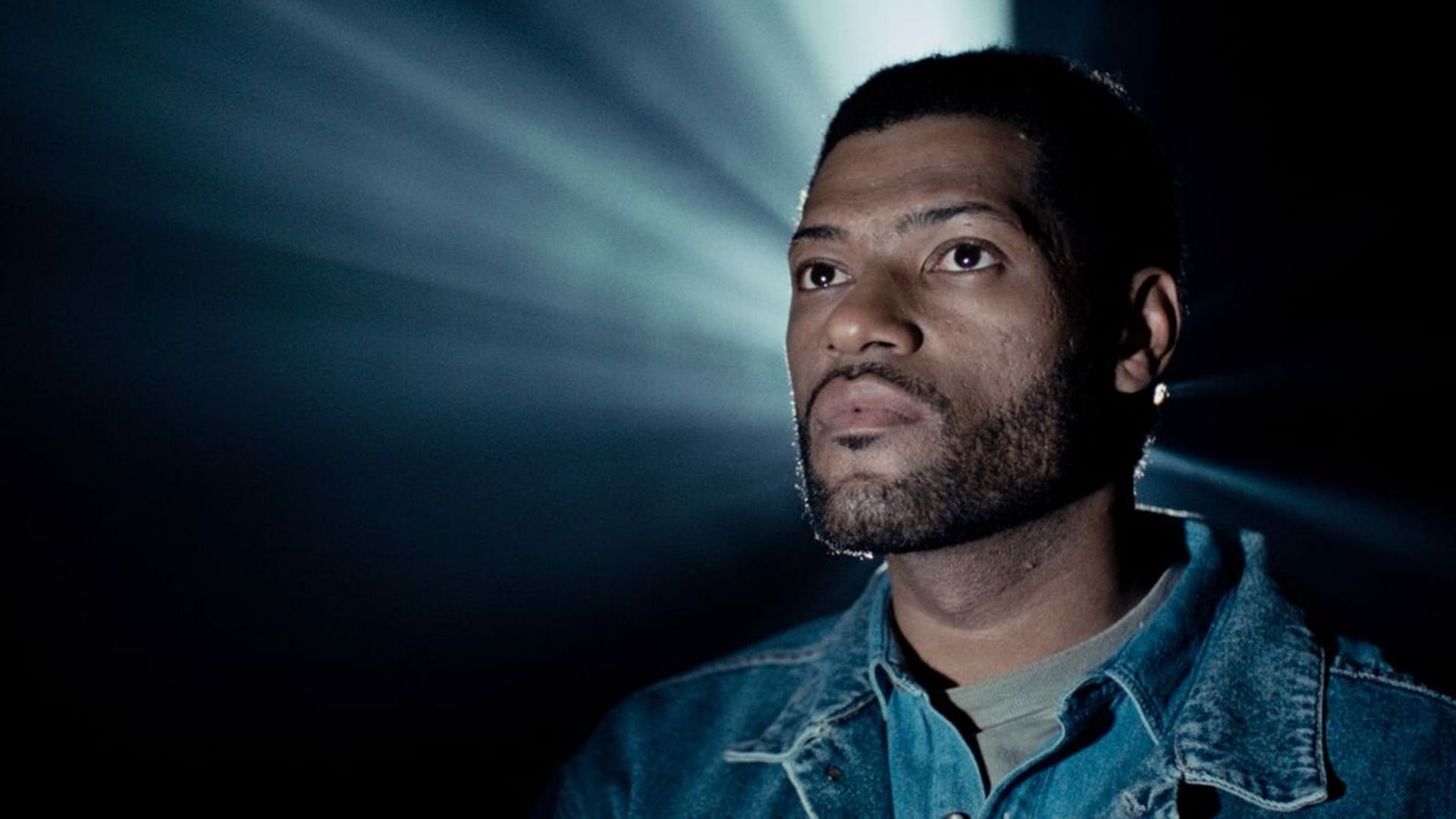 Russell sits in a theater in Deep Cover