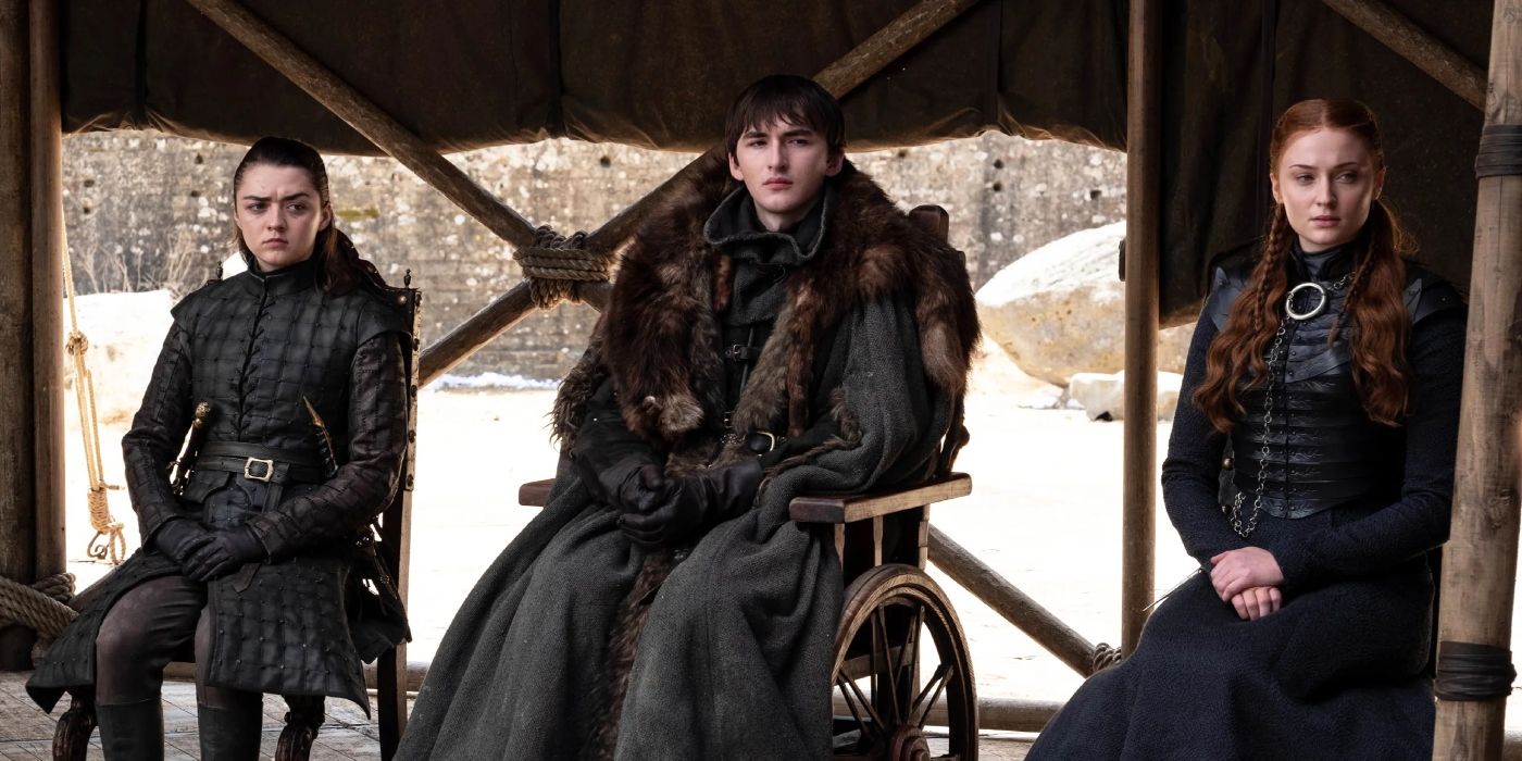 Arya, Bran, and Sansa sitting together in Game of Thrones.