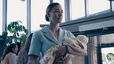 Under The Gilead regime Handmaid’s children are taken from them at birth, woman holding baby