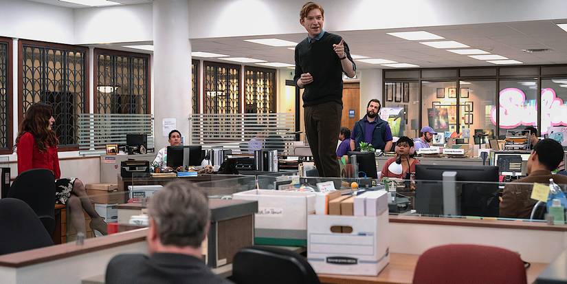 Domhnall Gleeson's Ned Sampson standing on a desk in the middle of The Paper