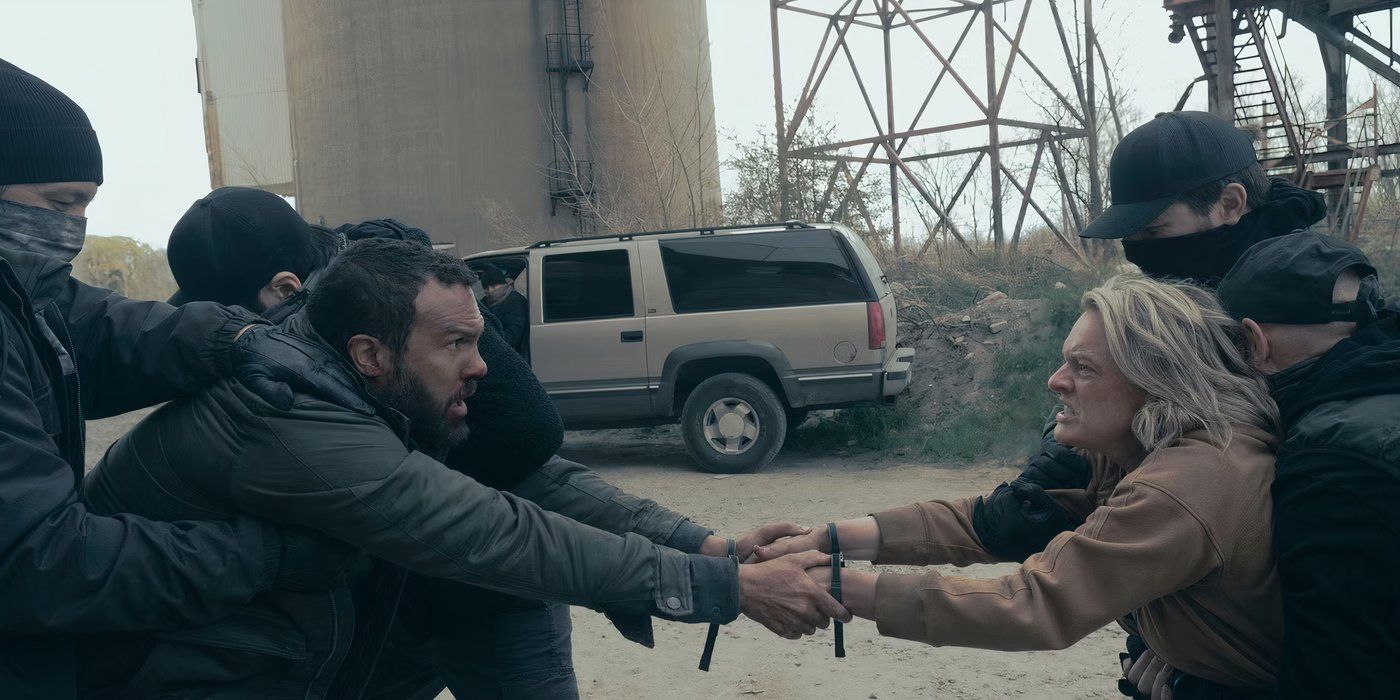 Men ripping Luke and June apart as they hang on to one another in The Handmaid's Tale (1)