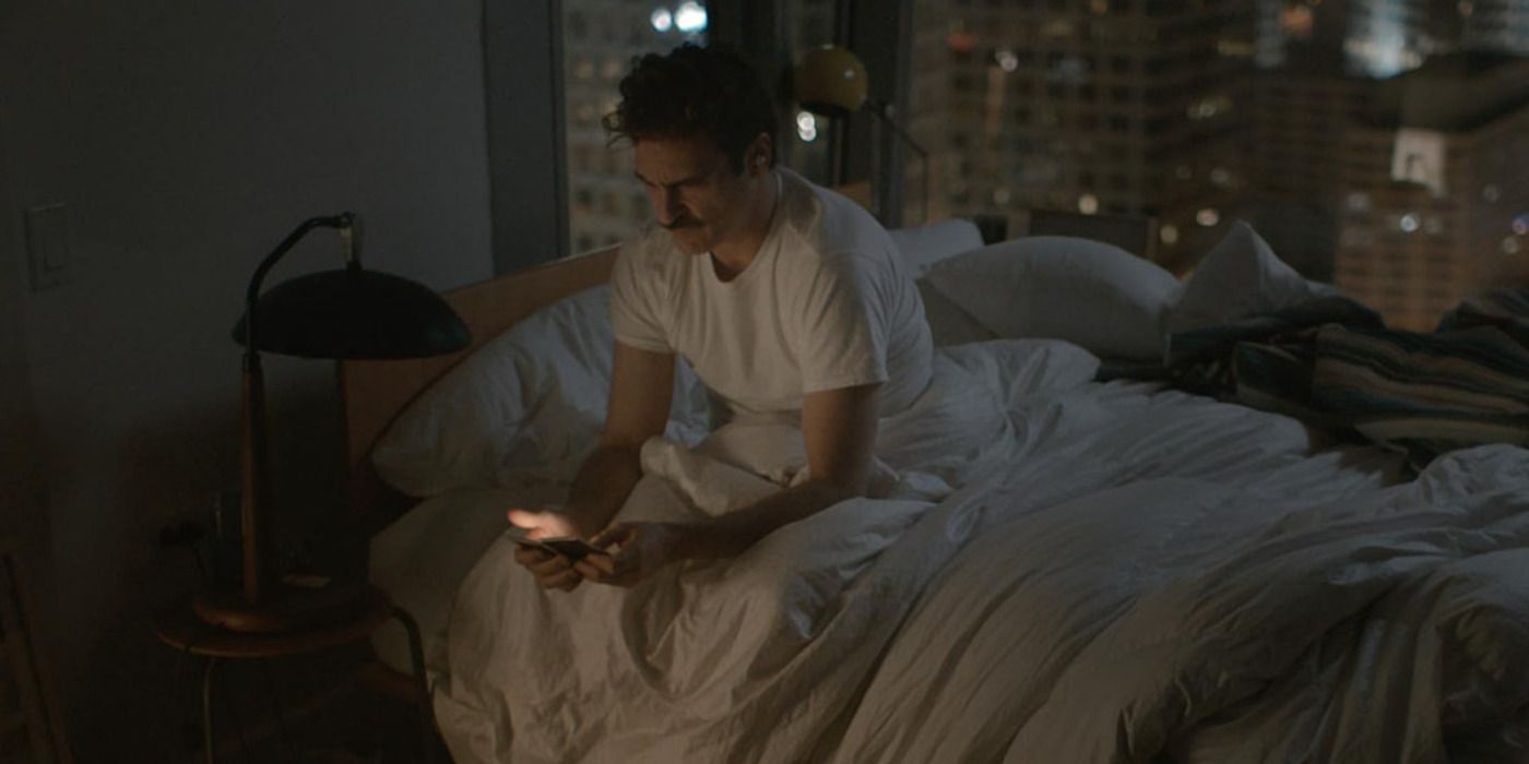 Spike Jonze's Her with Joaquin Phoenix staring at his phone in bed