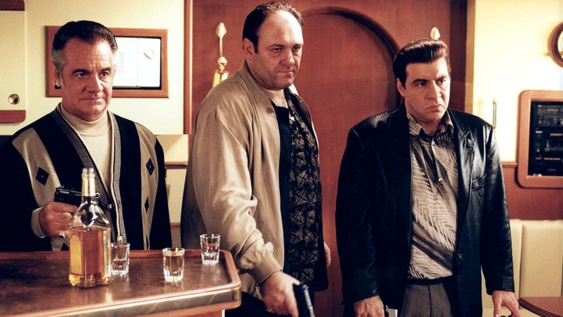Paulie, Tony, and Sil hold guns in The Sopranos