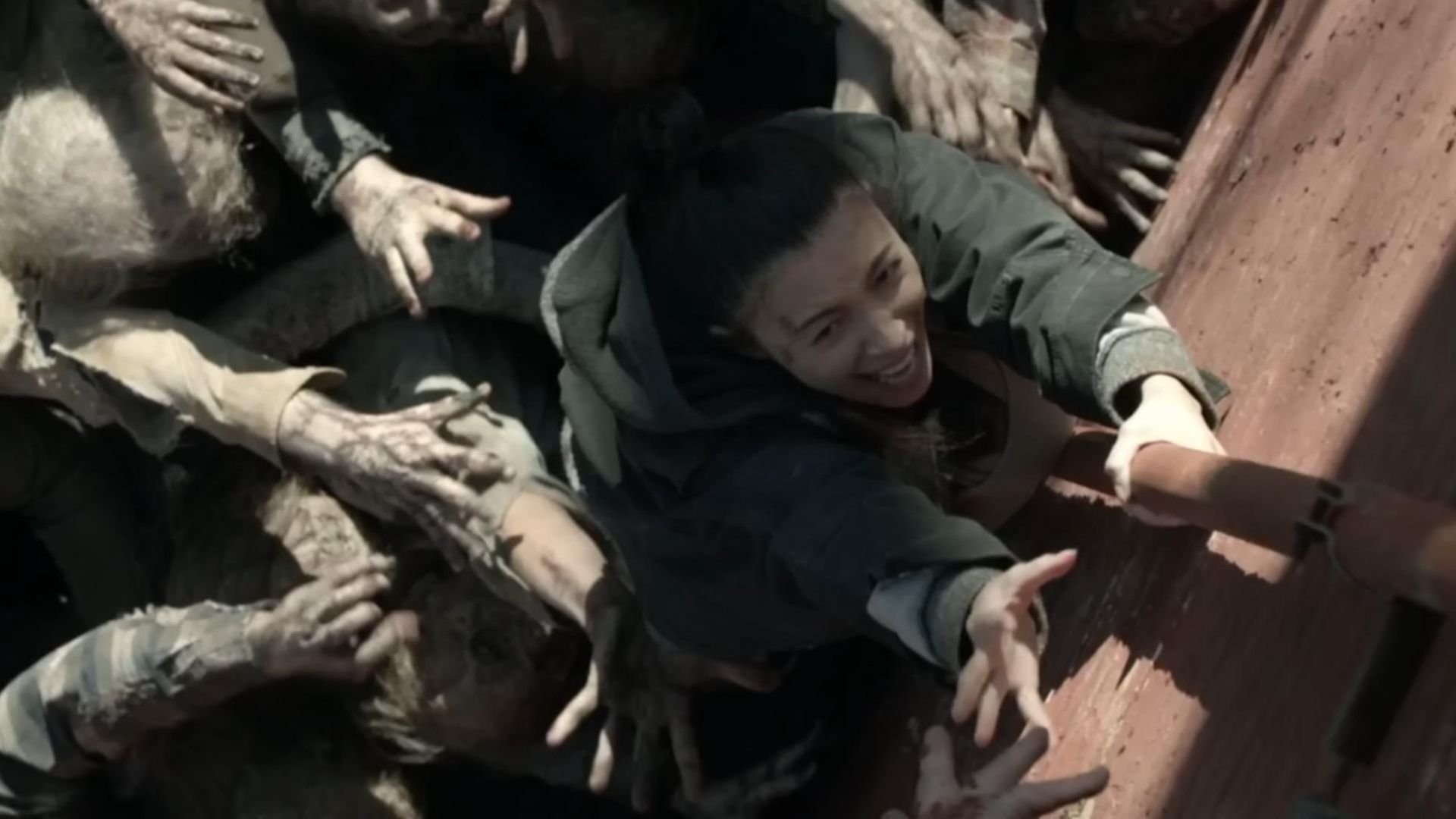 Rosita hangs on to a pole in The Walking Dead